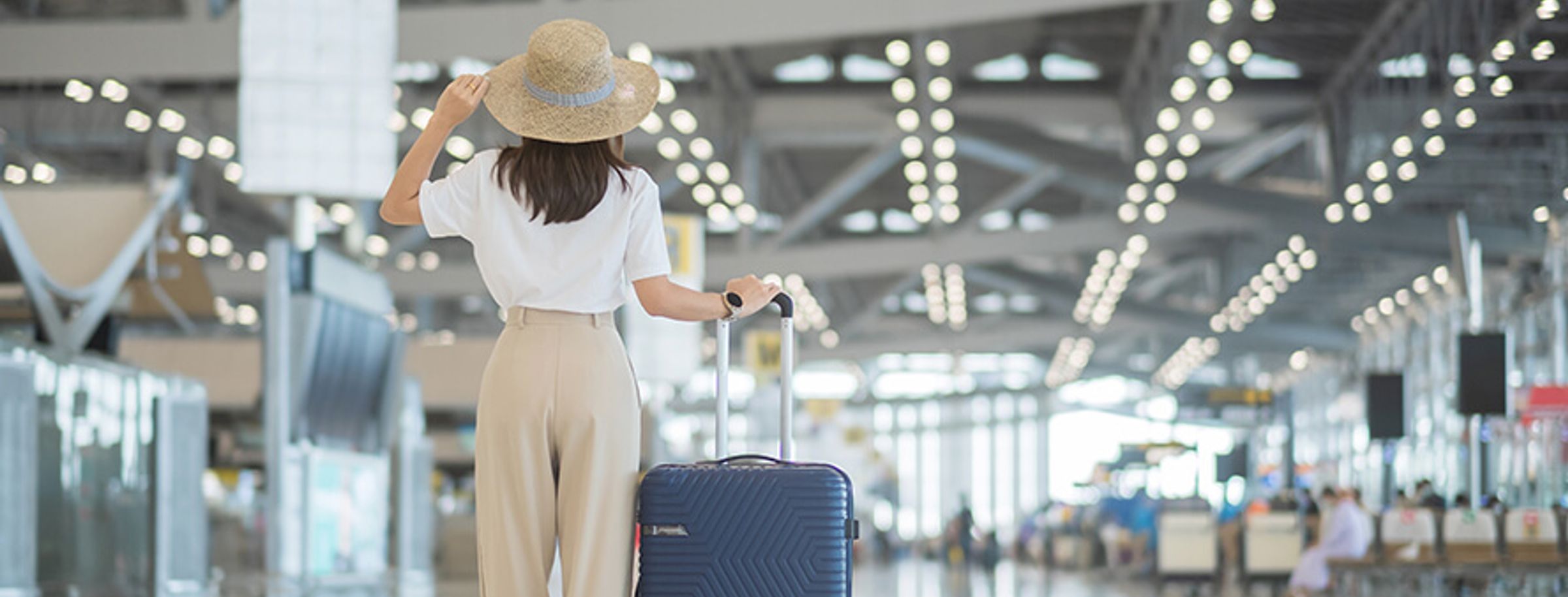 A woman travelling abroad with a suitcase