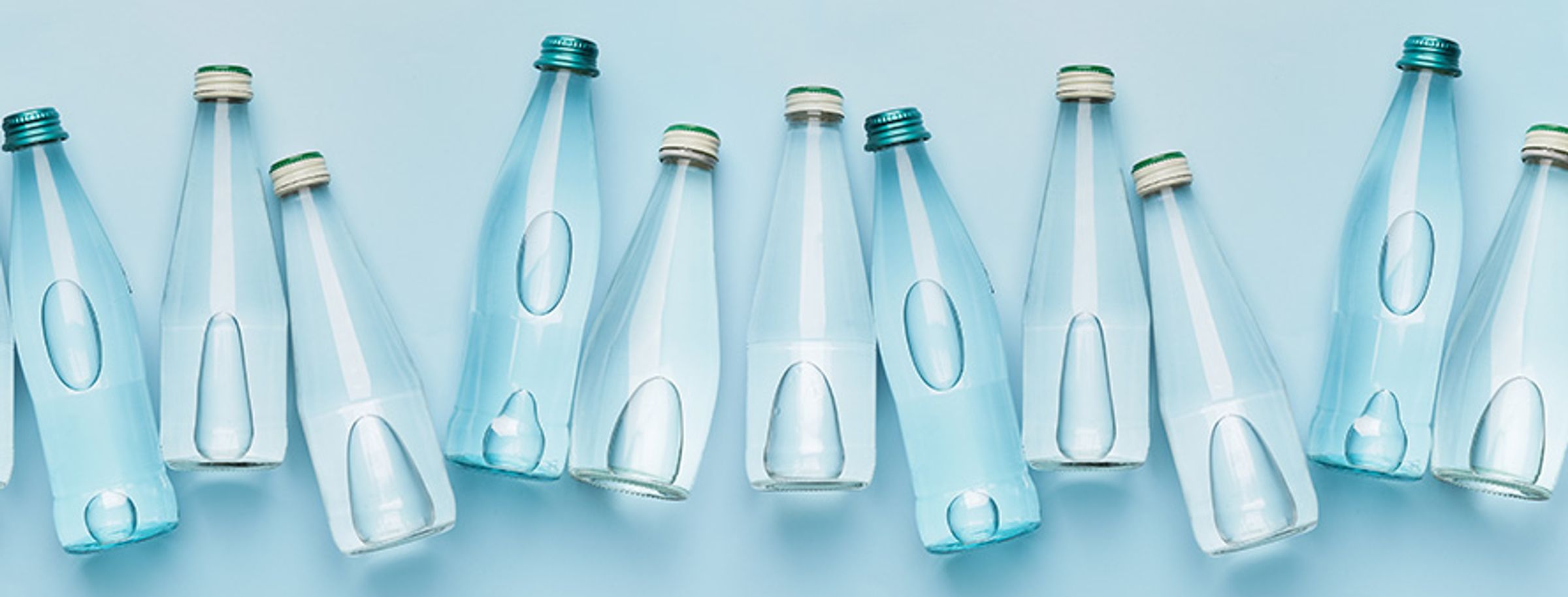 Bottles of water lined up on a table