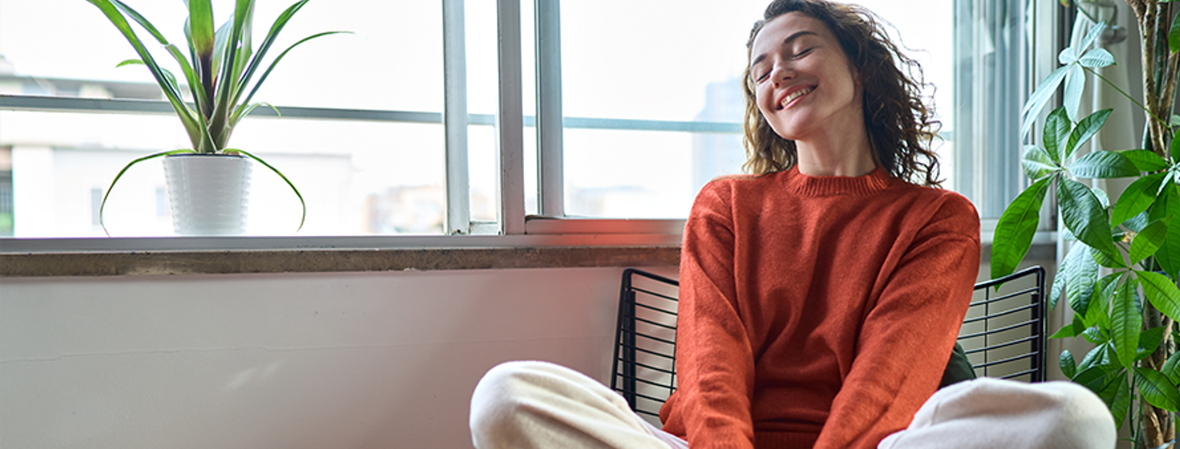 A woman smiling while relaxing outdoors