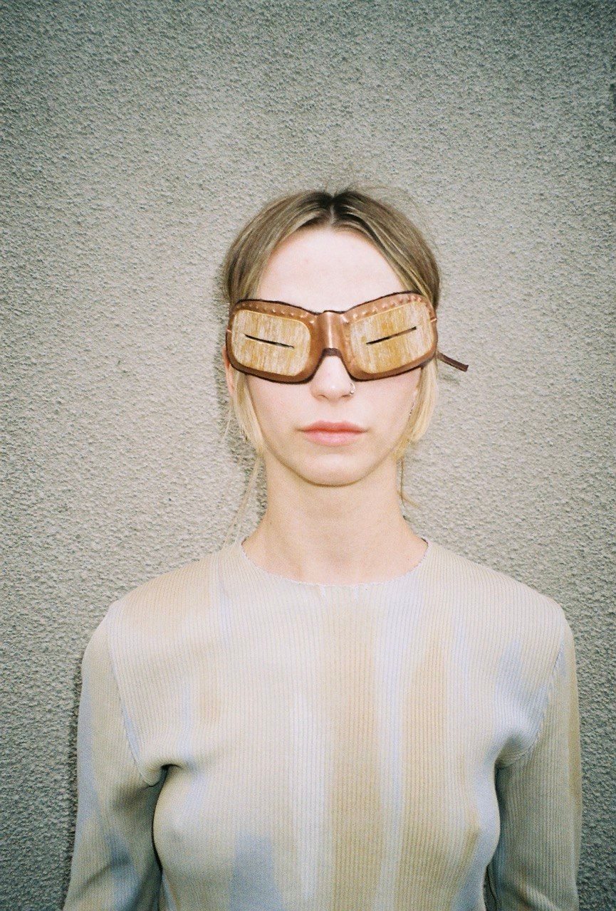 woman wears mammoth tusk goggles
