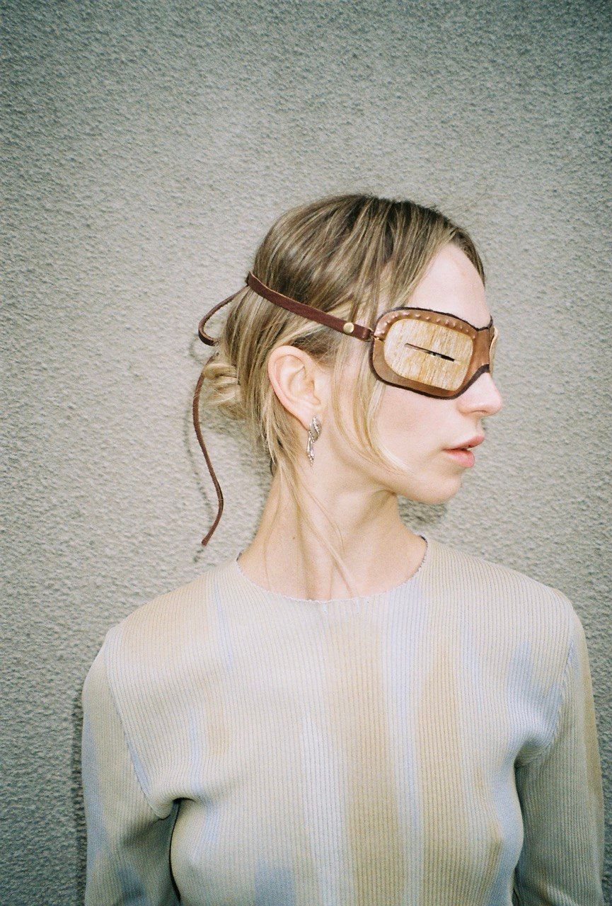 woman wears mammoth tusk goggles side view