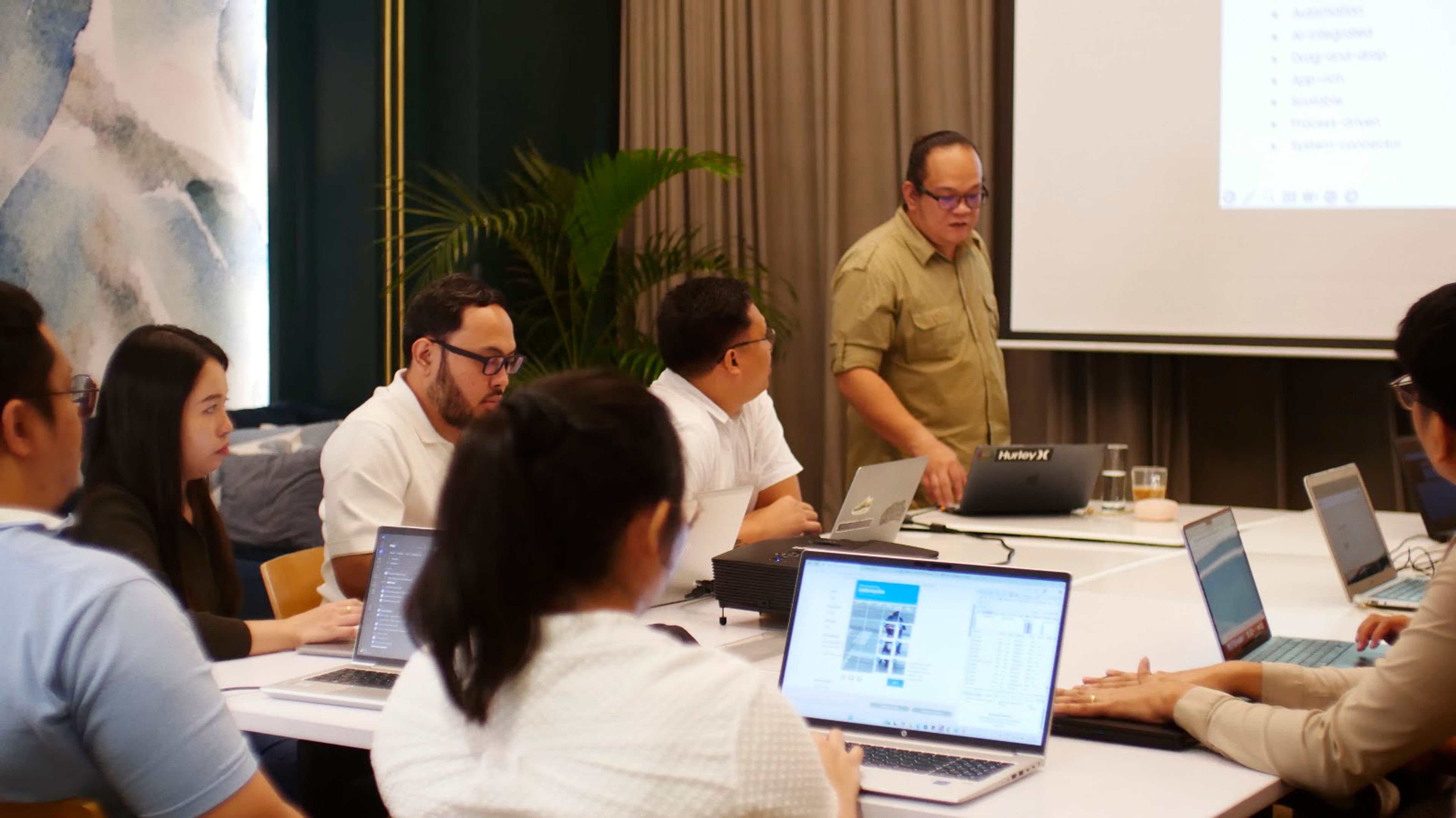 Colleagues taking part in a training session around a table