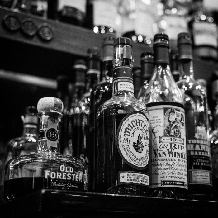 Rare bourbons on the Rock and Rye back bar, in black and white
