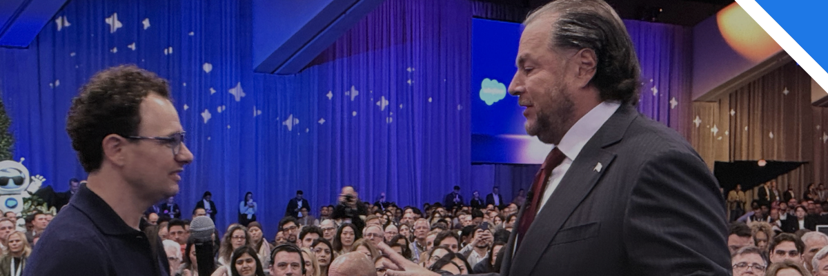 Wide shot of Anthropic CEO Dario Amodei holding a microphone while standing in the crowd to speak with Salesforce CEO Marc Benioff during the keynote session