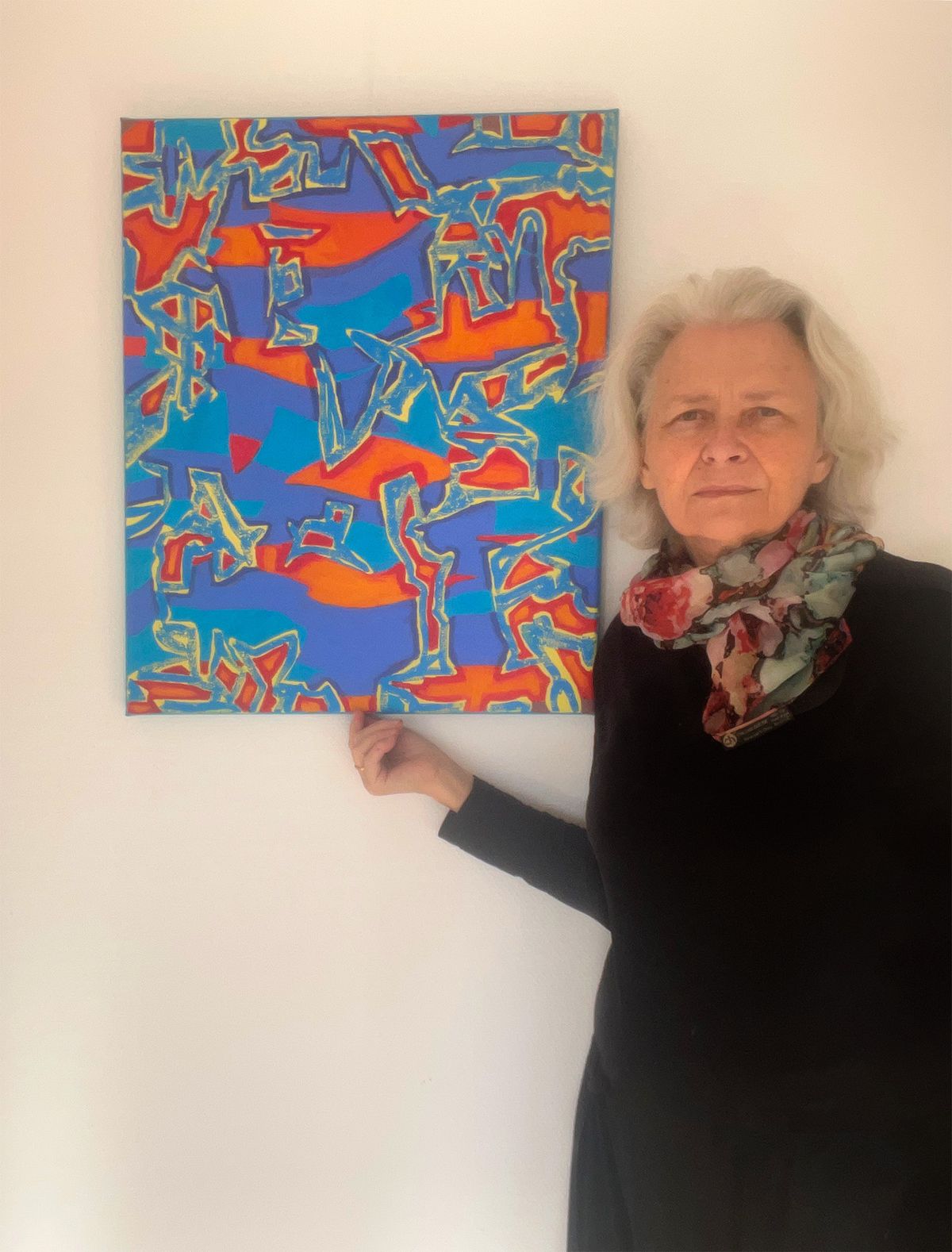 Artist Jolanta Johnsson with abstract oil painting with blue and red tones
