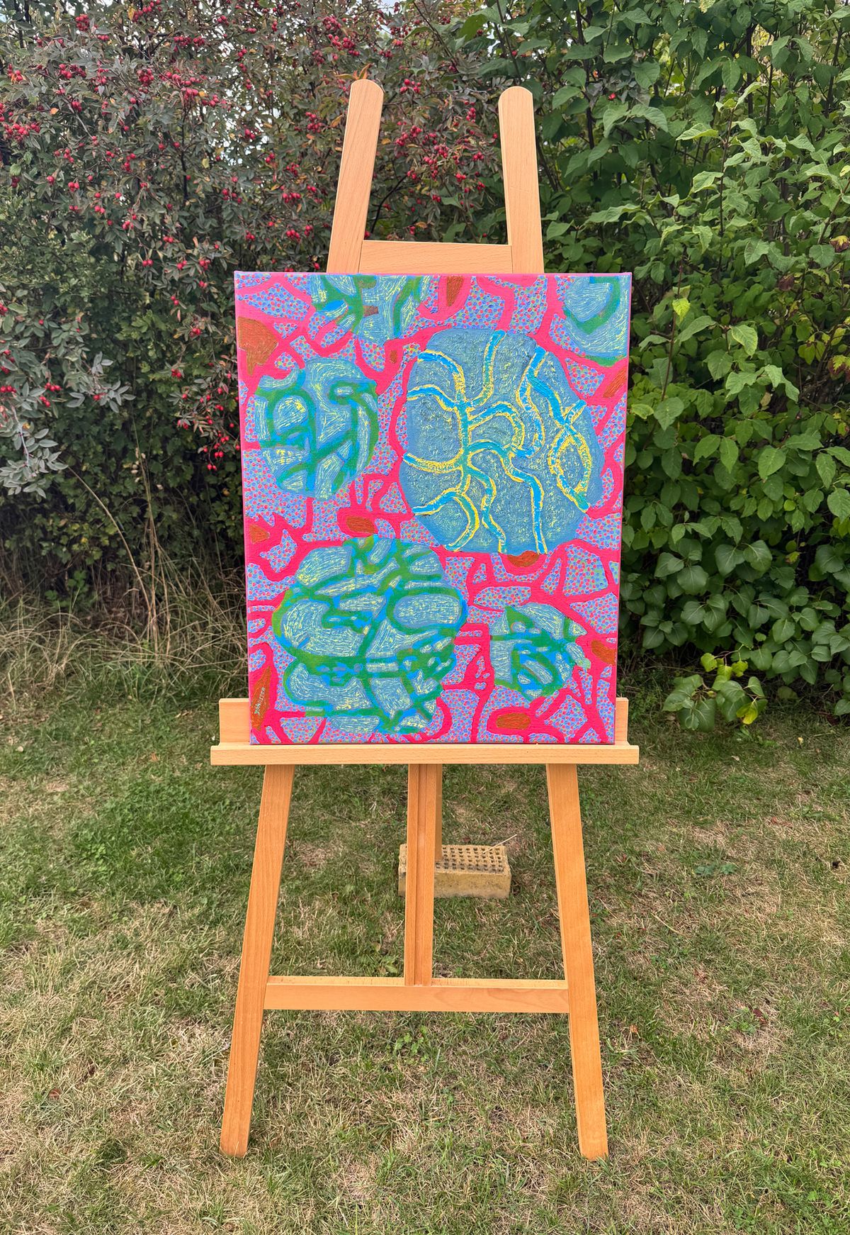 abstract oil painting with pink and green tones, on easel