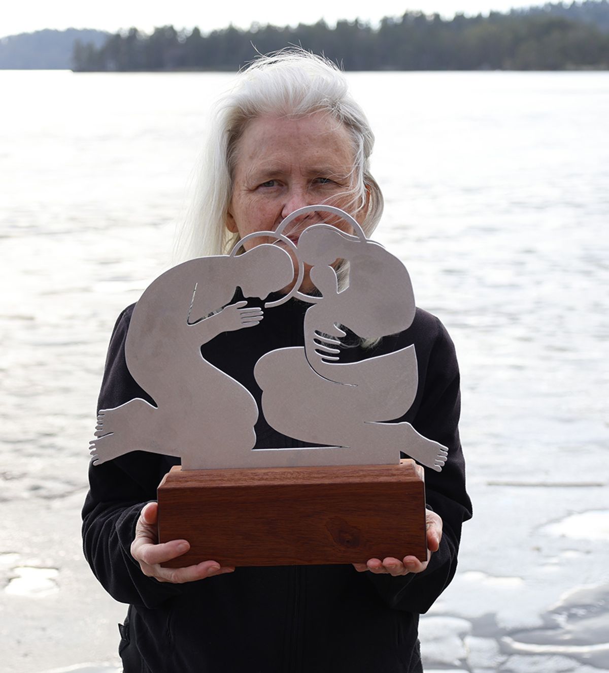 Jolanta Johnsson, Holy Family, artist holding the sculpture