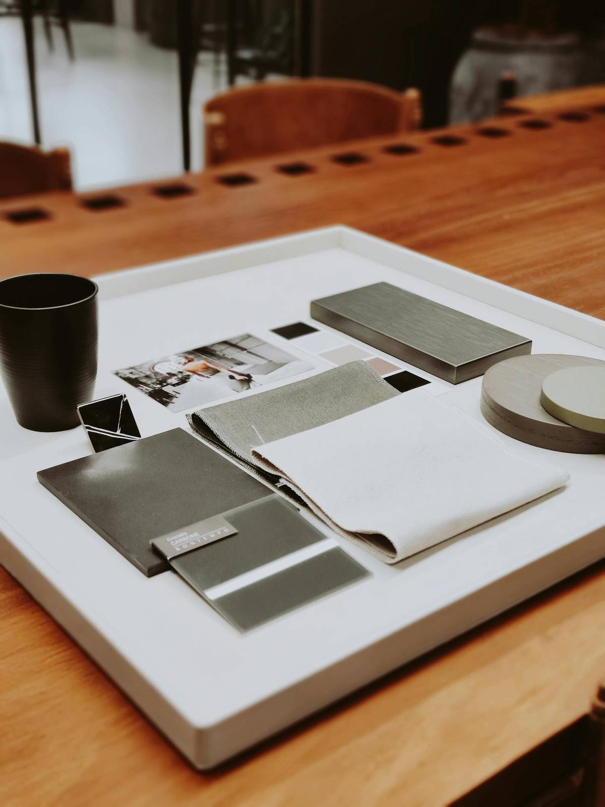 Fabric samples and material references arranged neatly on a desk for practical sustainability tradeoffs.