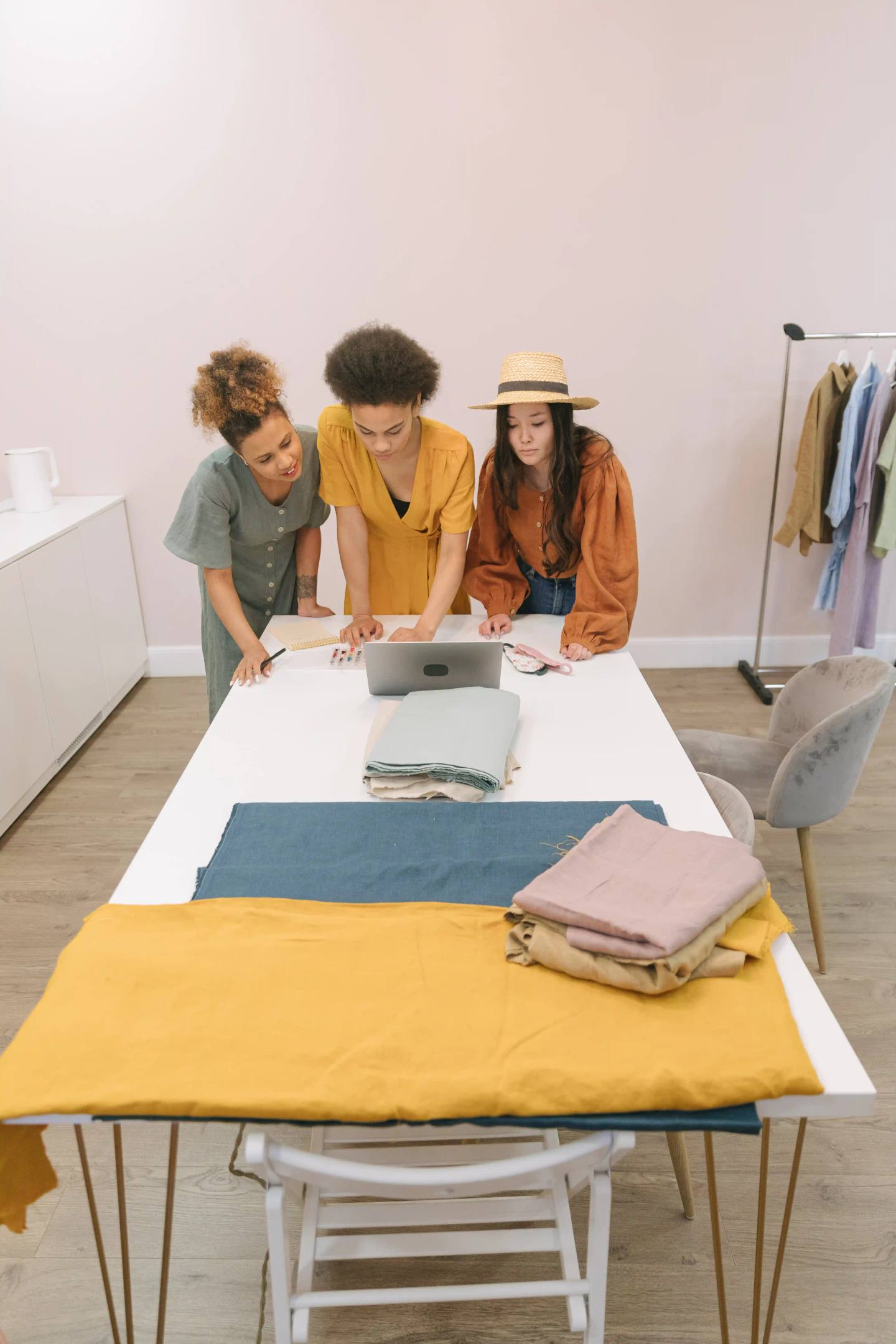 Fashion team planning fabric choices and production steps for a small apparel brand