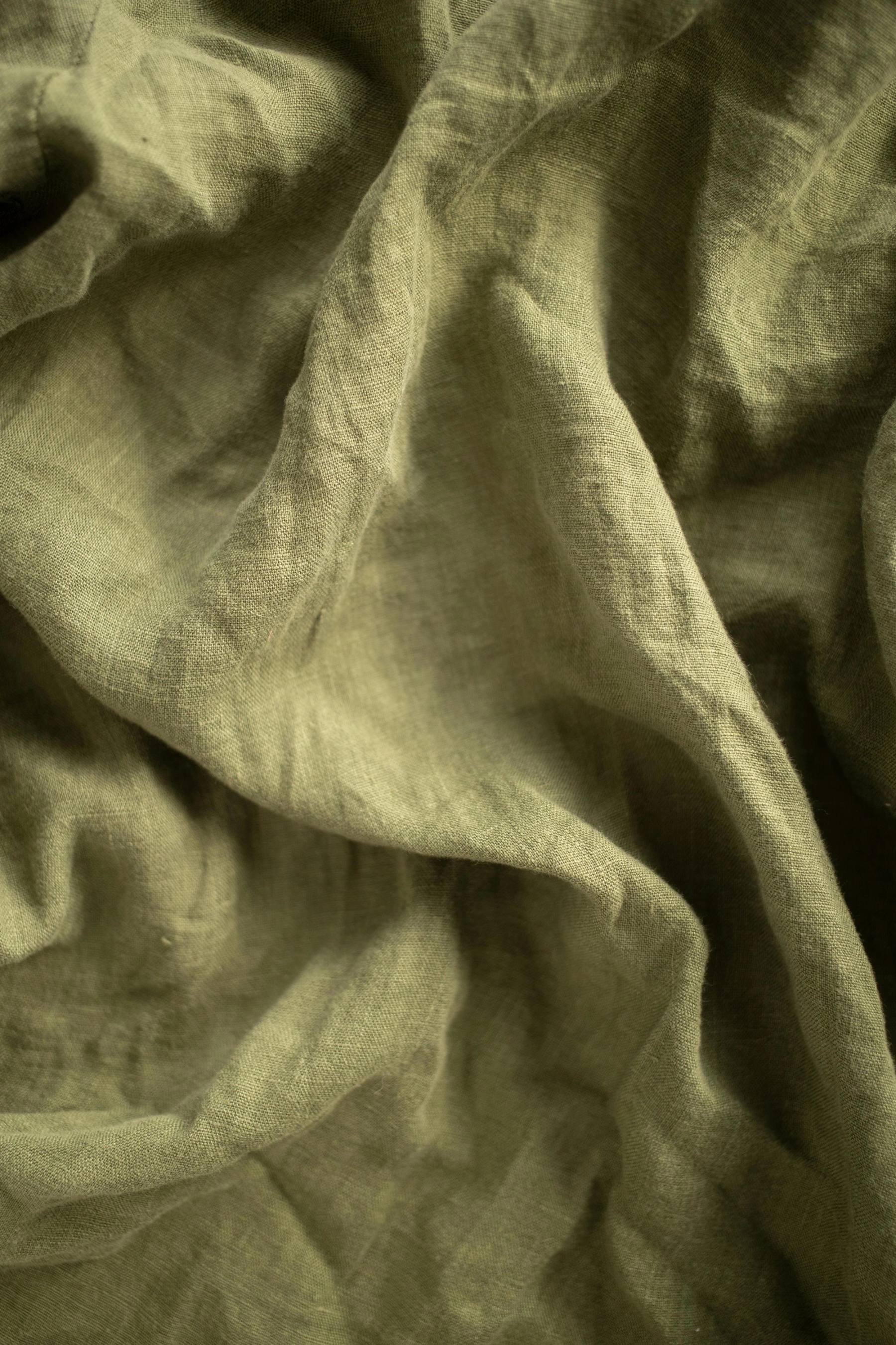 Olive green linen fabric texture for sustainable apparel development