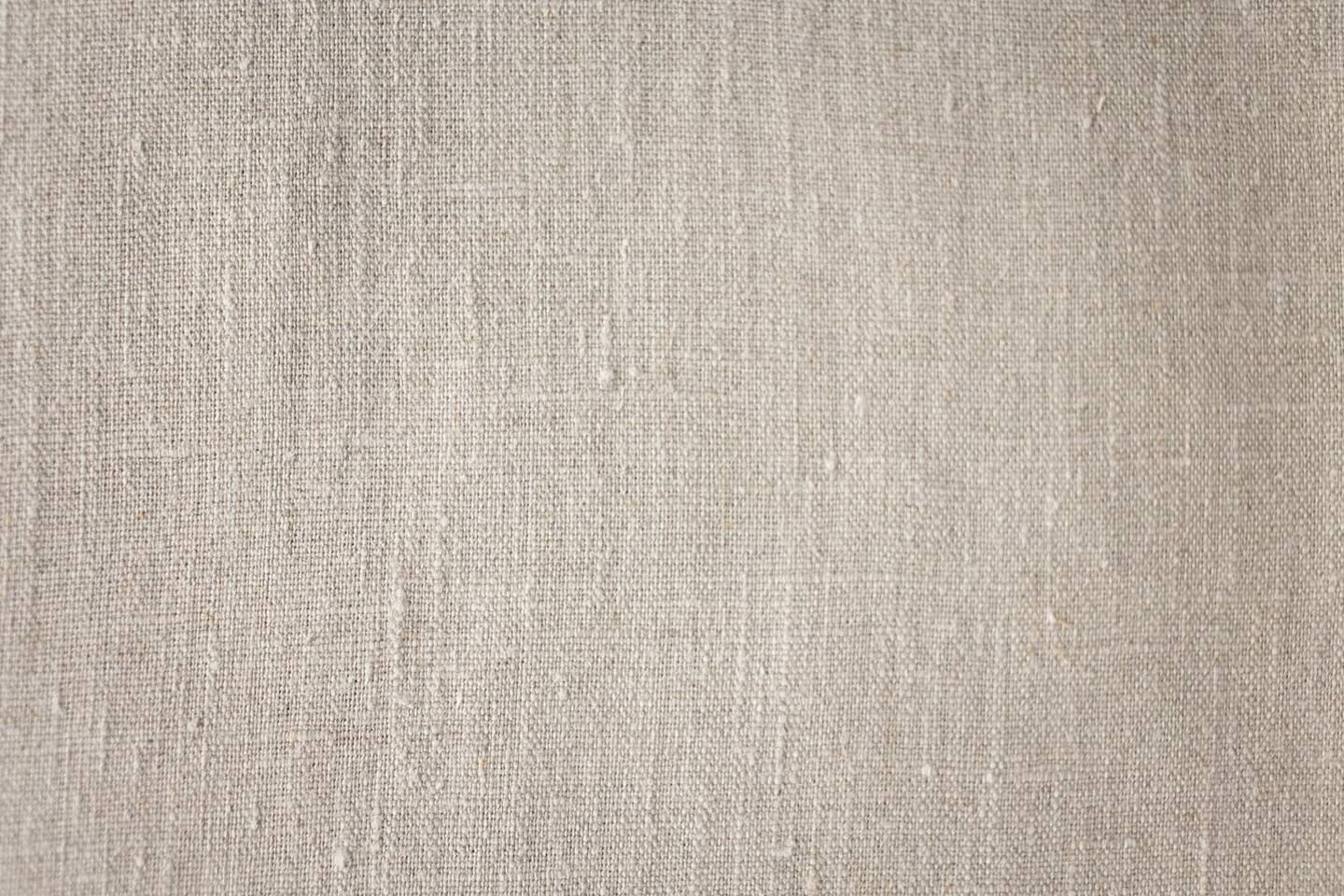 A close-up linen texture showing natural woven fibers and realistic material character.