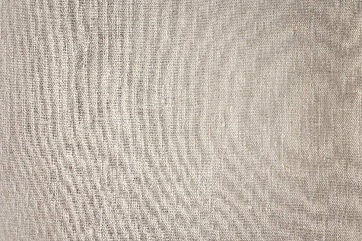 A close-up linen texture showing natural woven fibers and realistic material character.