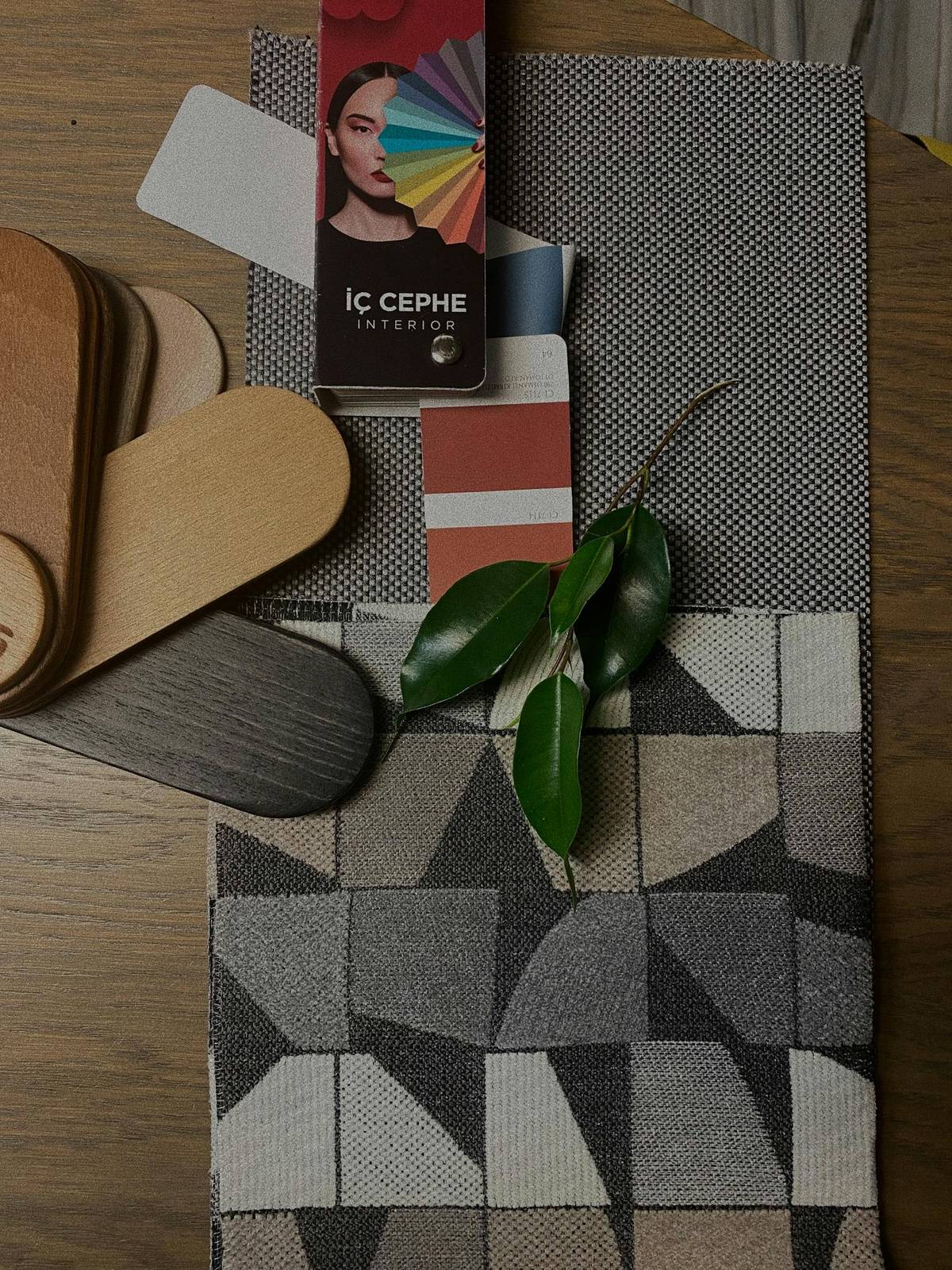 Cloth samples, swatches, and material references arranged on a table for planning decisions.