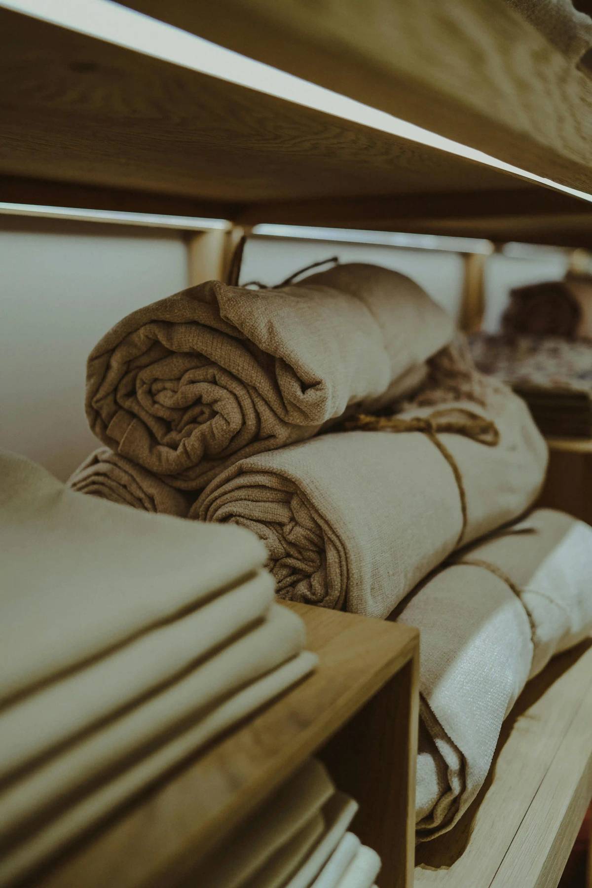 Neutral fabric rolls on shelves for small-batch apparel sourcing