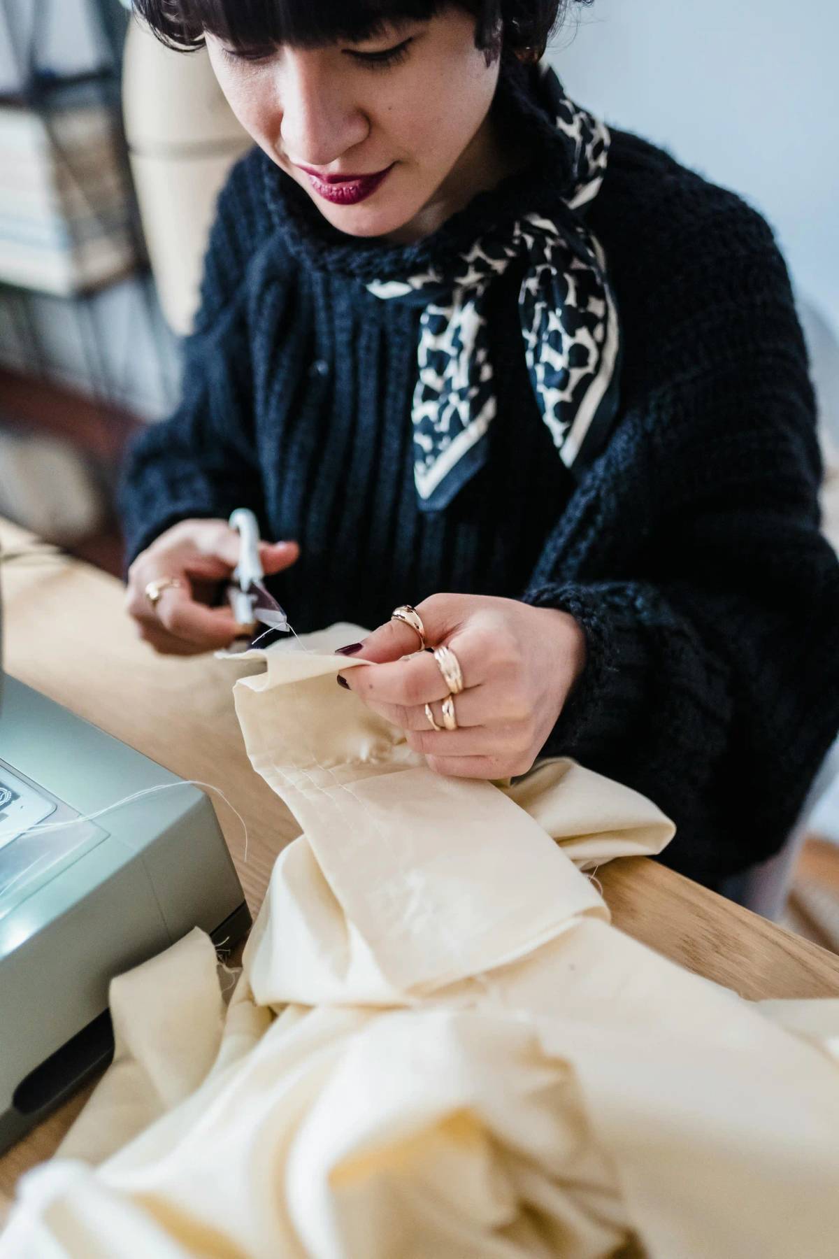 Tailor cutting fabric on a worktable during small-batch garment development