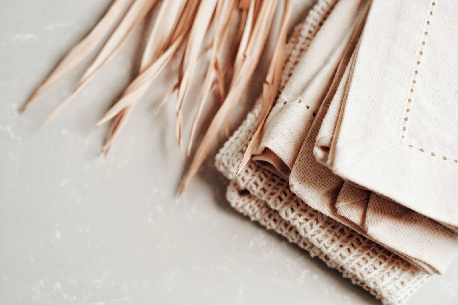 Close-up of neutral linen and cotton fabrics with natural texture.