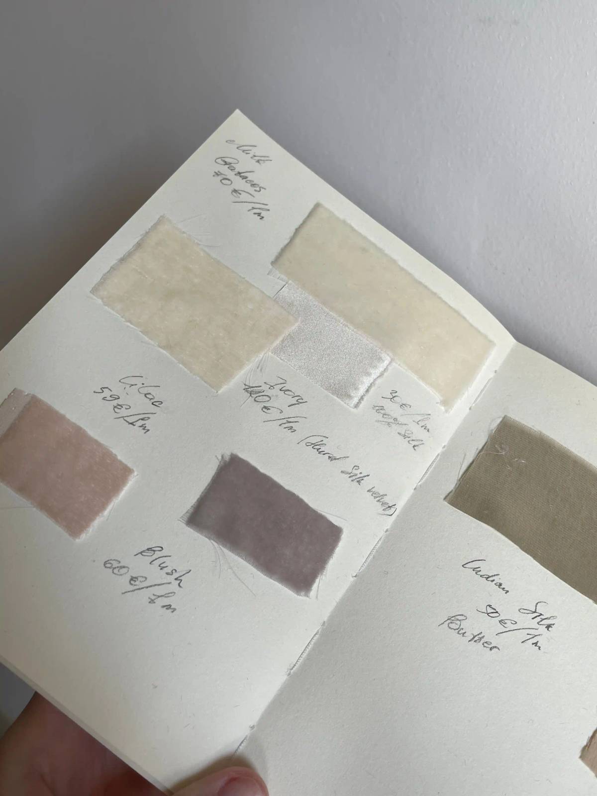 Fabric samples and material references arranged neatly on a desk for practical sustainability tradeoffs.