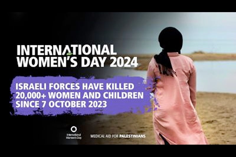 a woman in hijab walks alond a sandy strip of land with text overlay