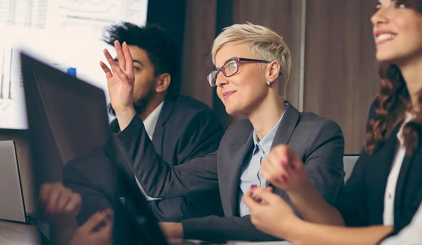 Woman raising her hand in a meeting