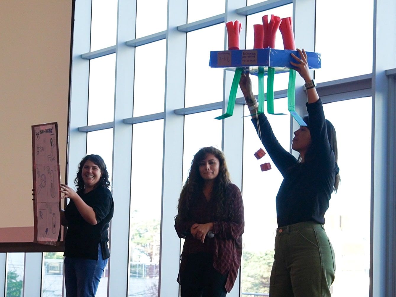 Un equipo levanta en alto la torre de vasos que construyó durante una dinámica