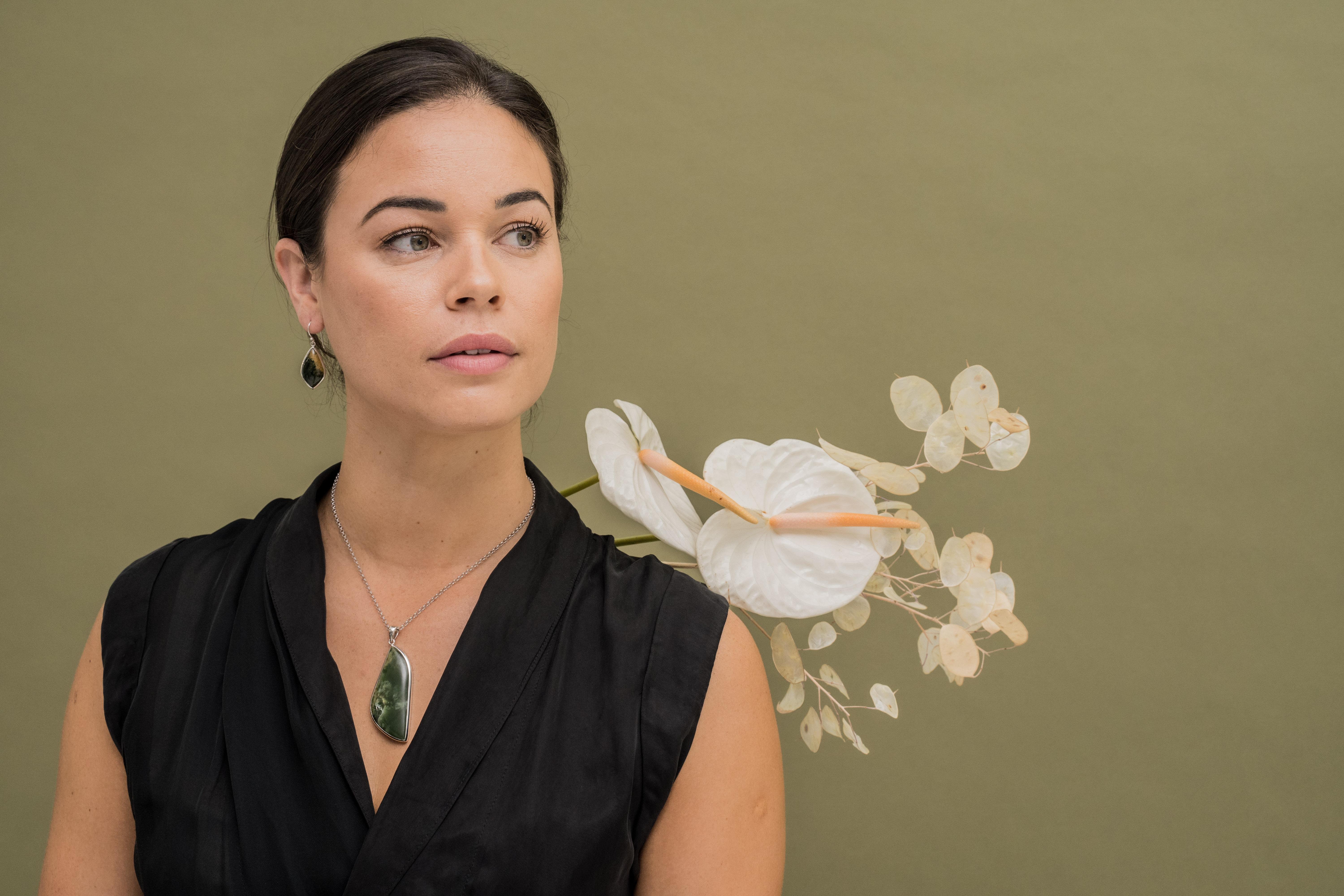 Lady wears pounamu and silver necklace