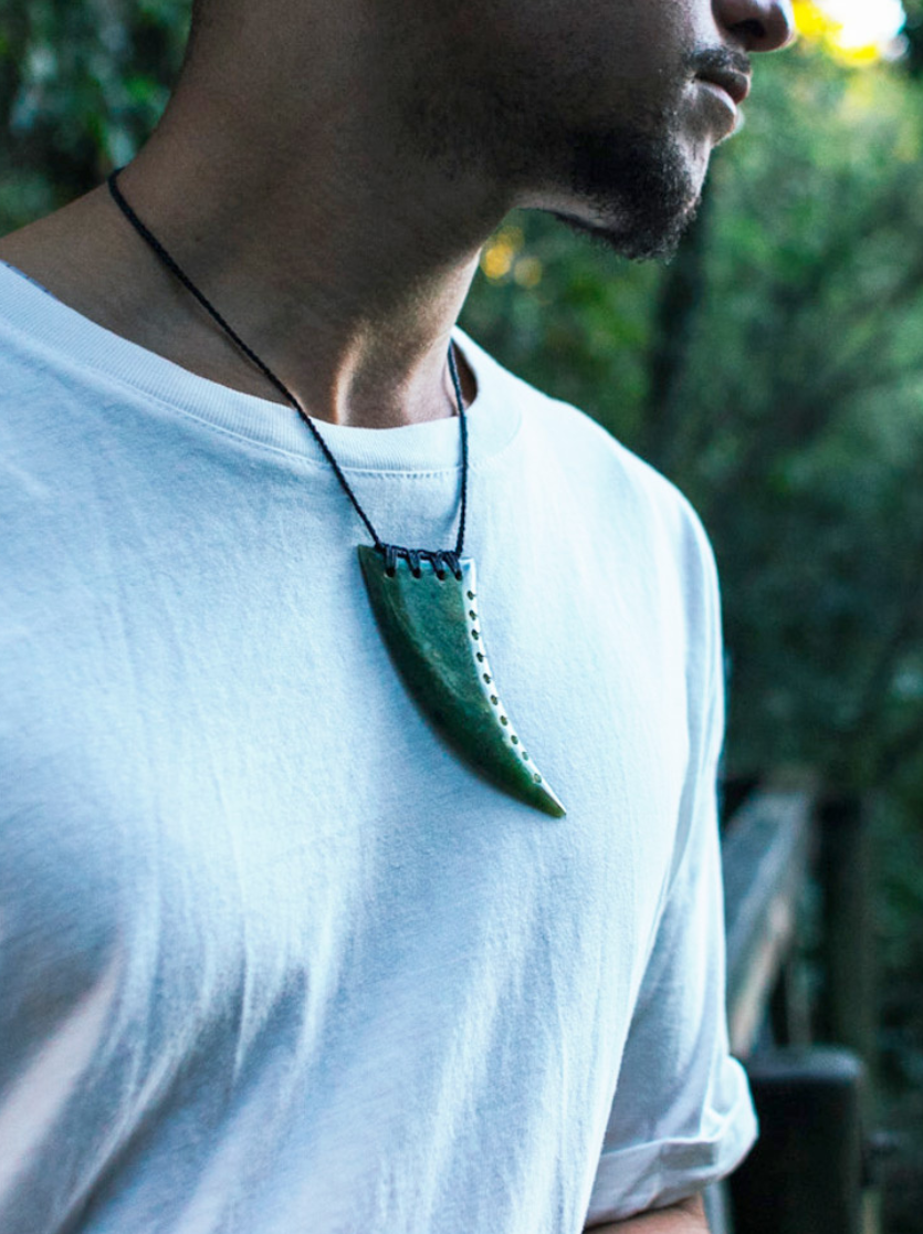 man wearing a pounamu shark tooth