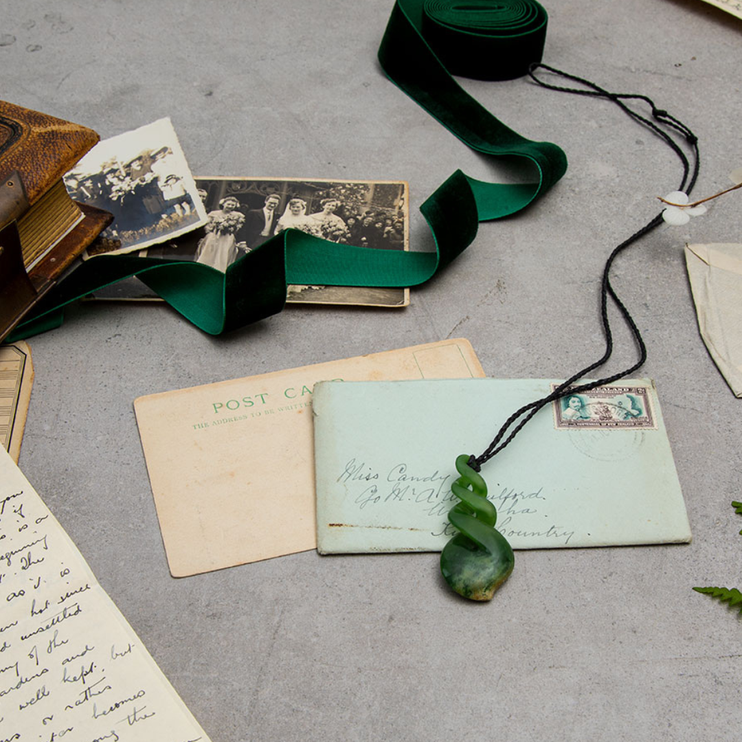 Pounamu Pikorua and envelope with seal