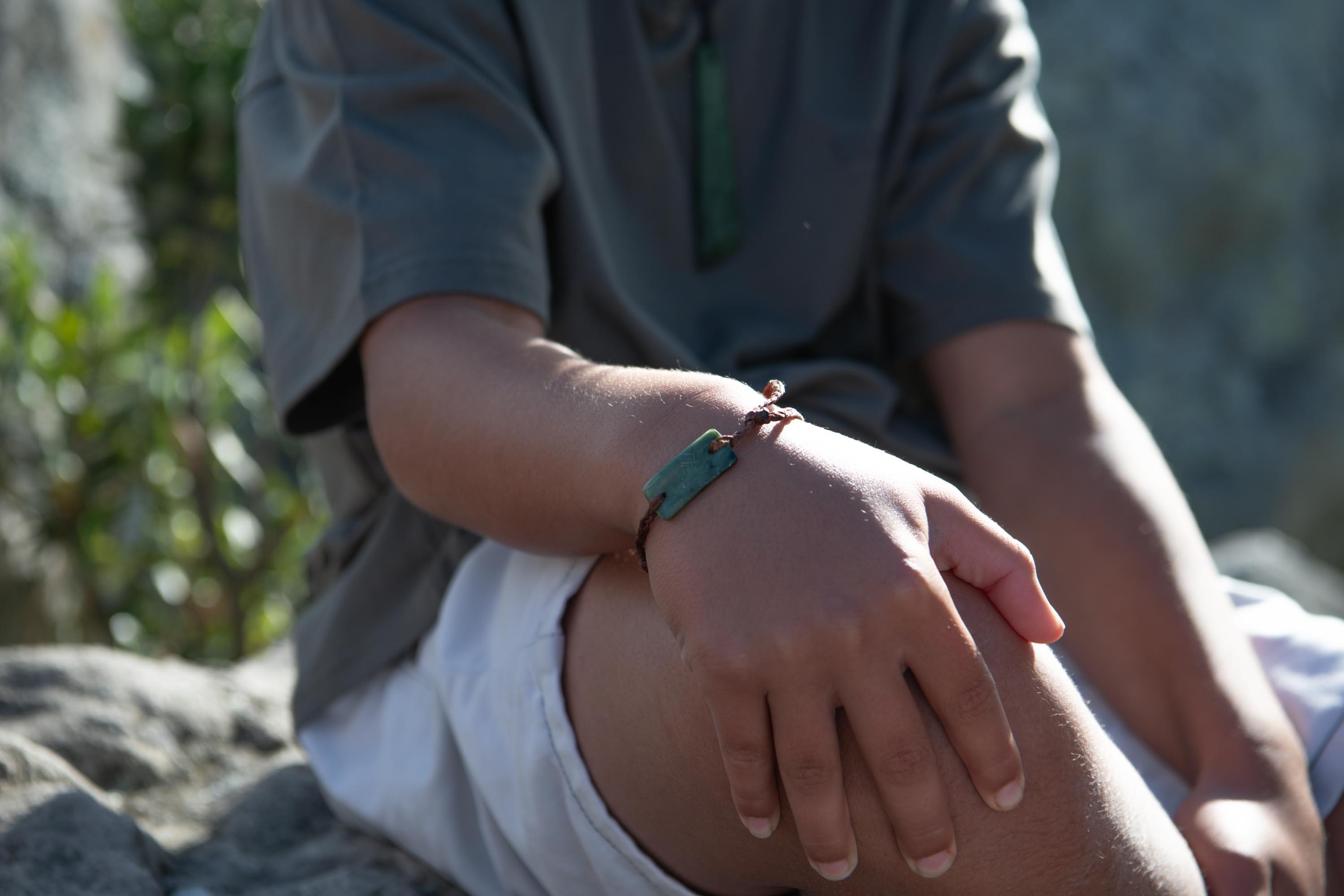 Child wearing adjustable pounamu bracelet
