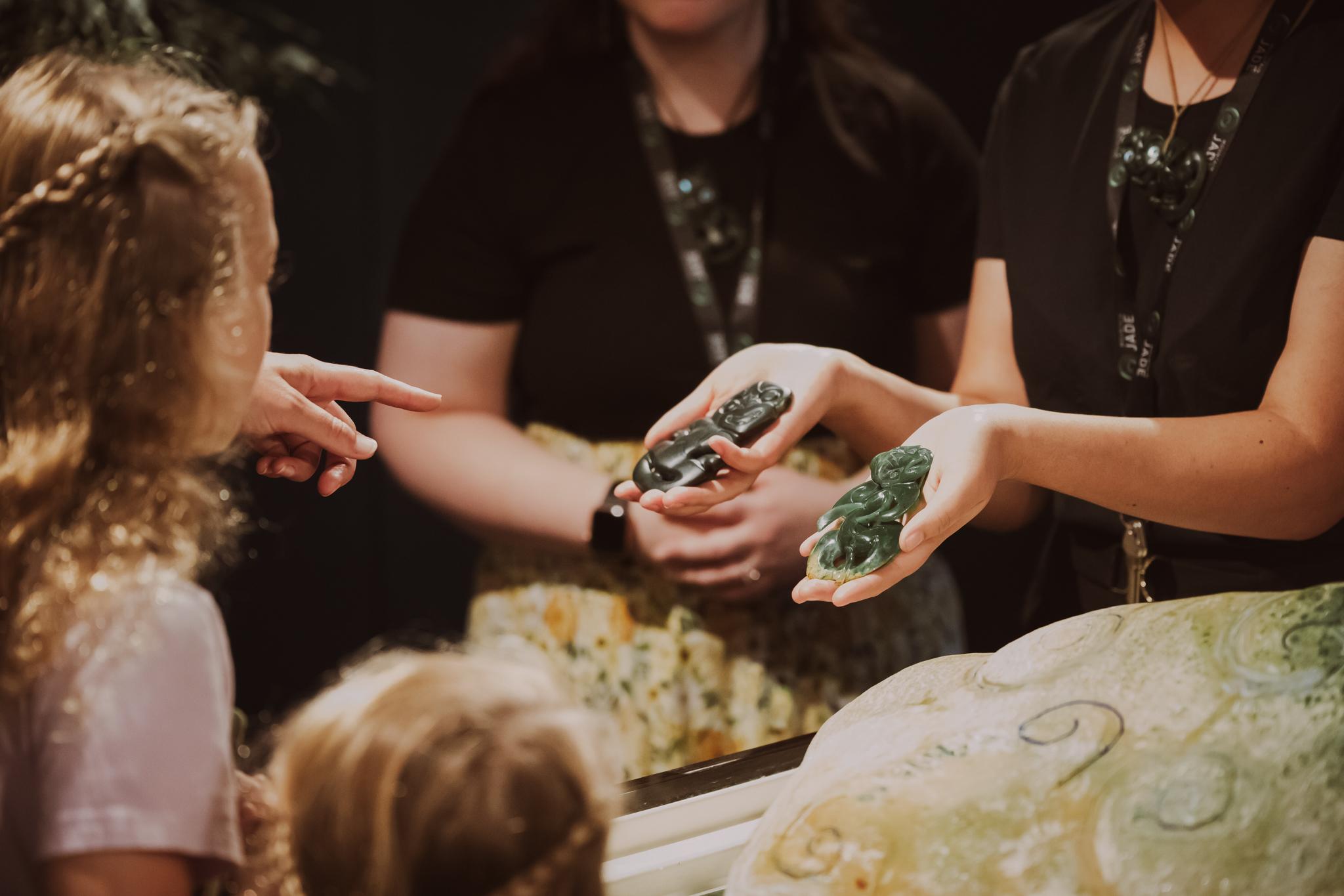 Visitors looking at a pounamu tiki