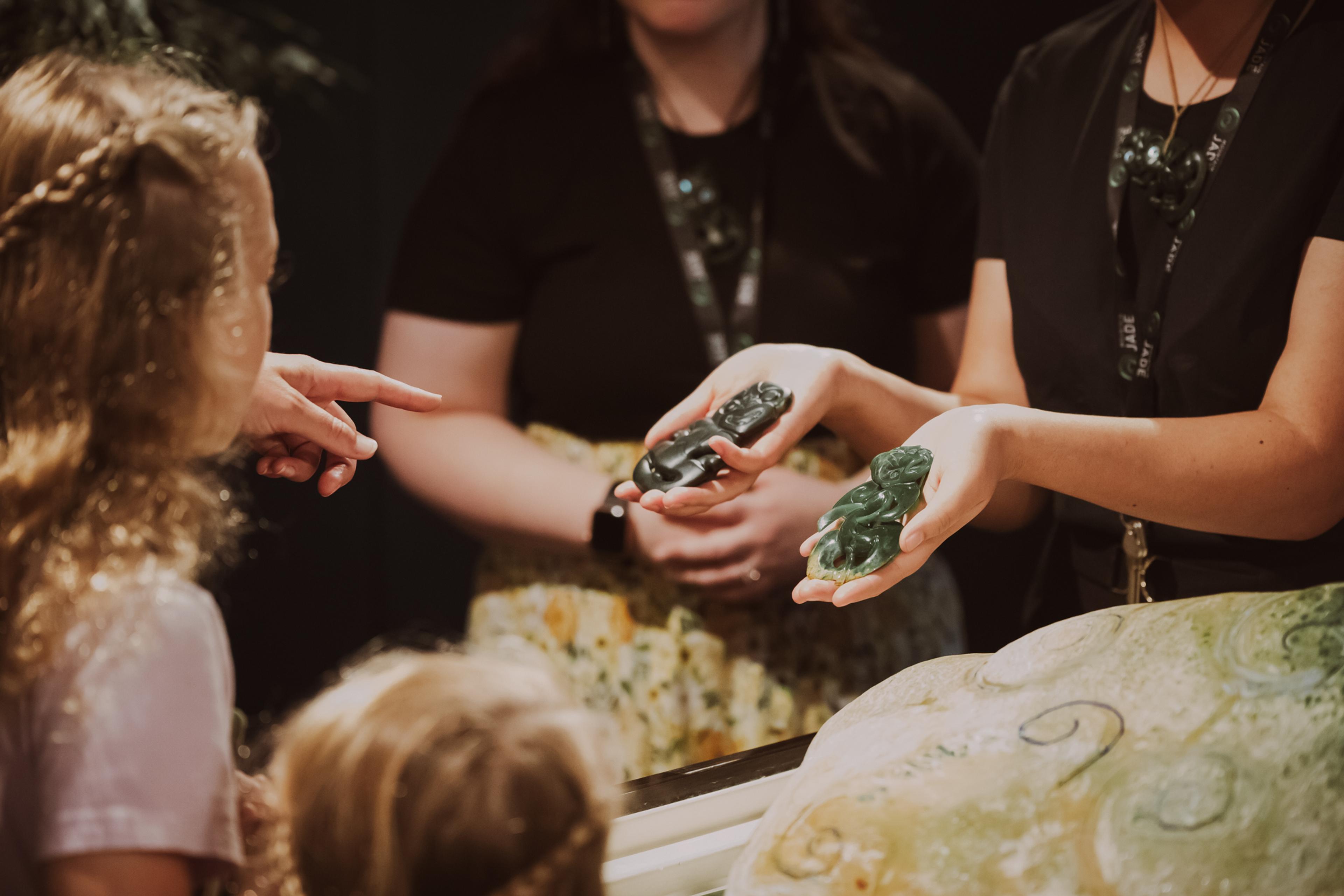 Visitors looking at a pounamu tiki