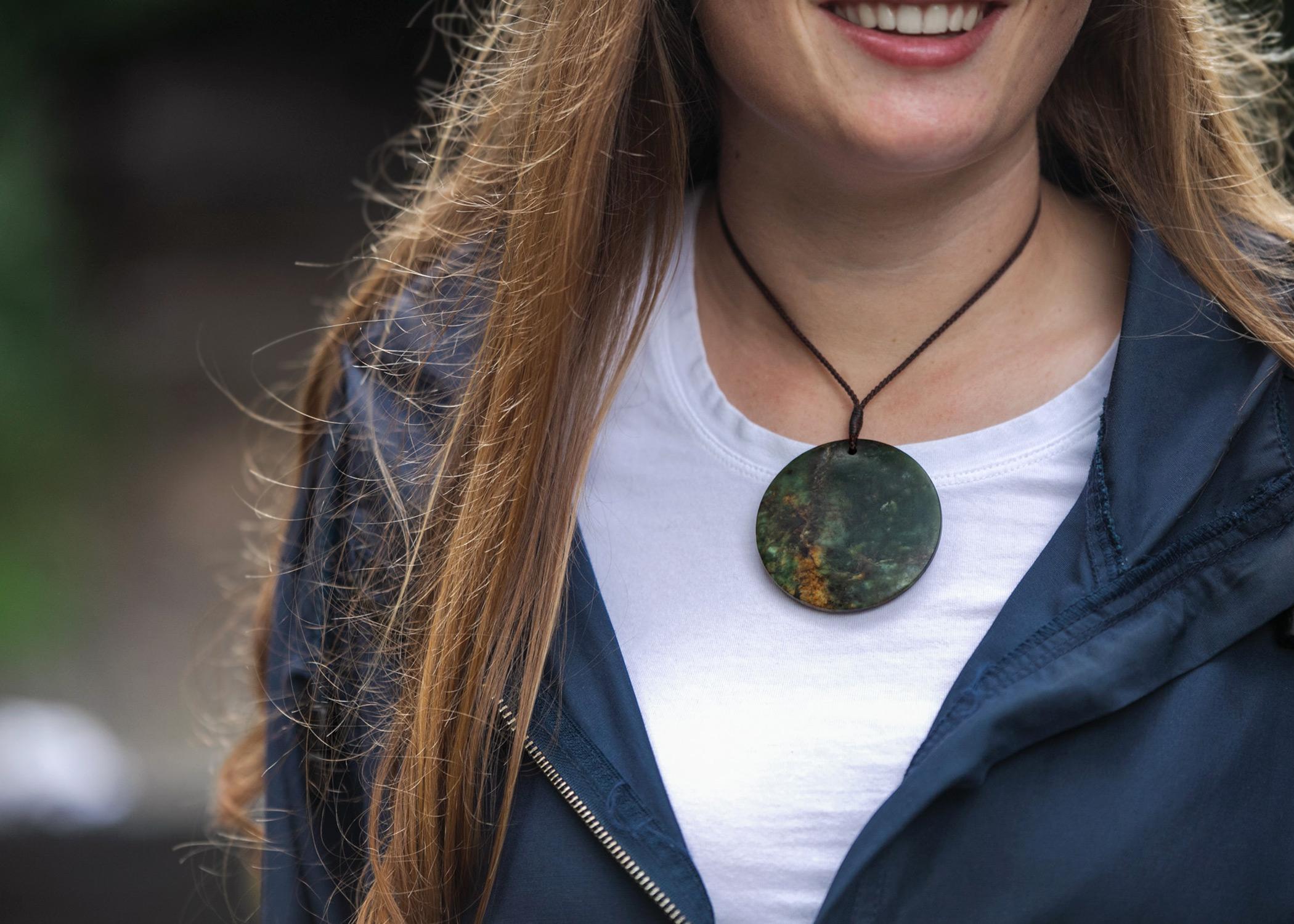 Model wearing Pounamu Disc with flower jade