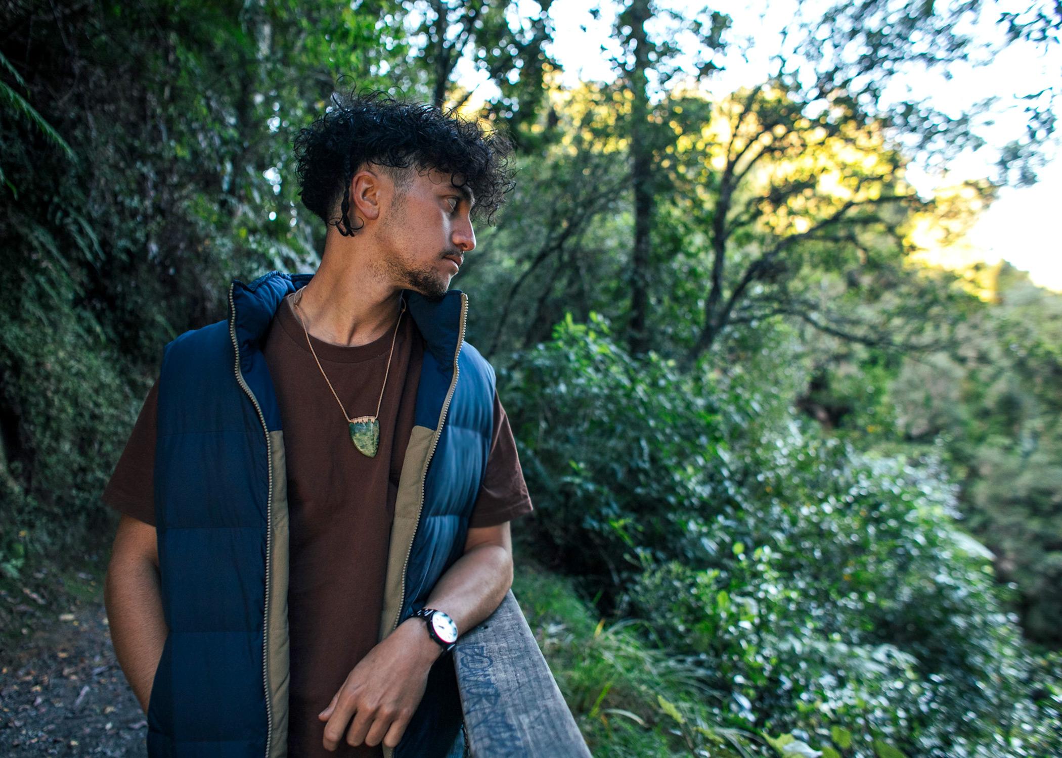 man wearing whale tooth pendant