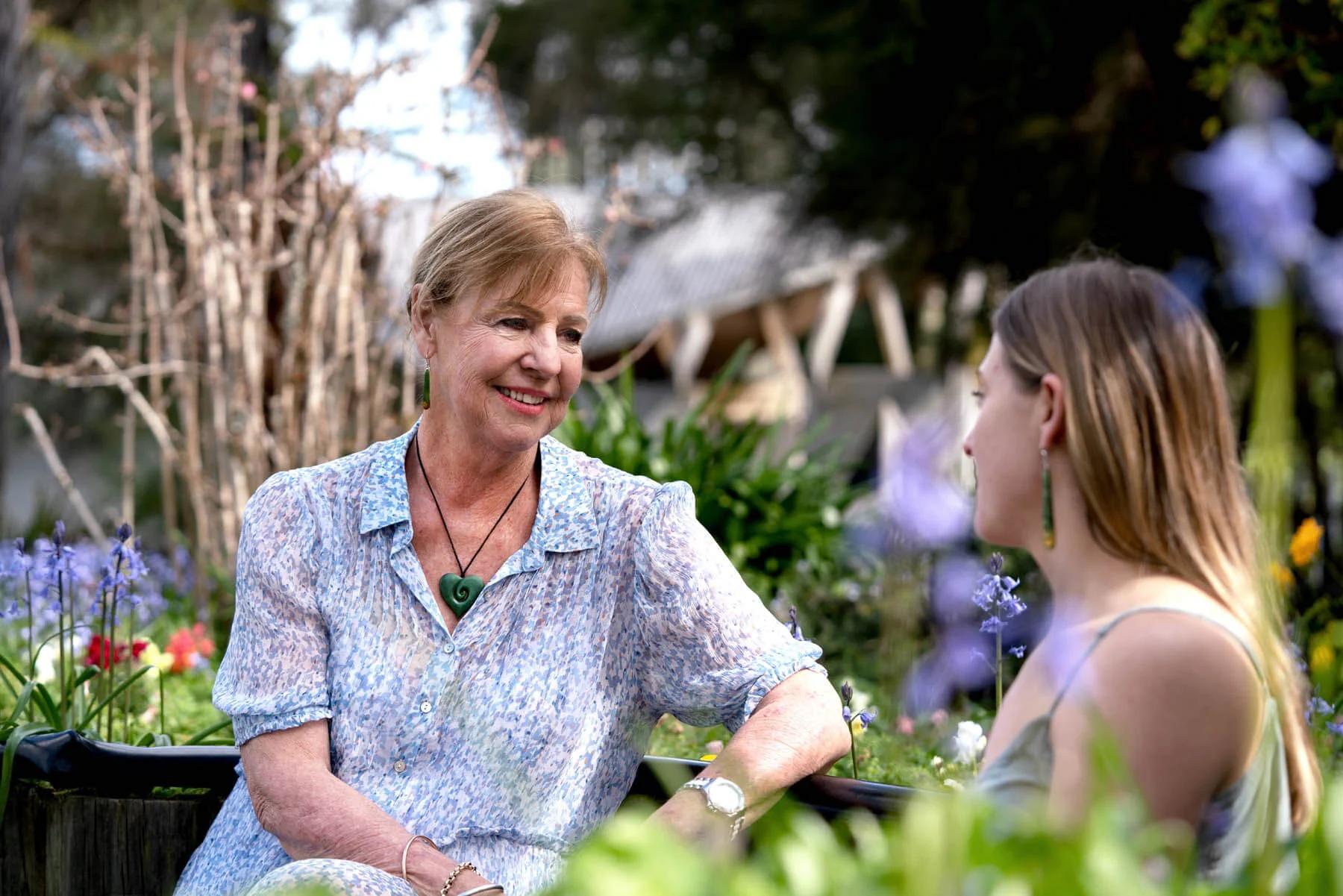 Mother talking to daughter wearing Heart Necklace