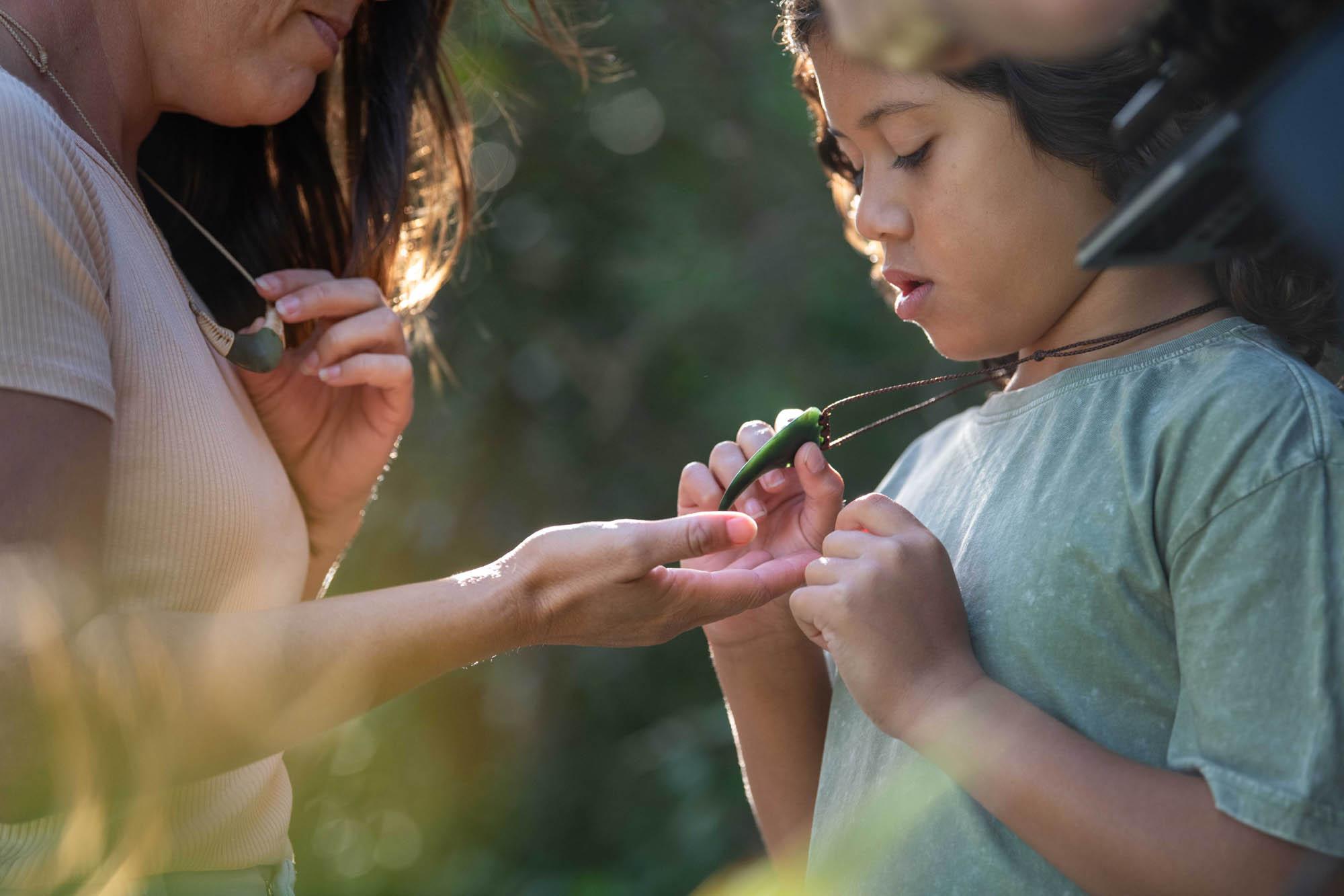 Child wearing pounamu tooth