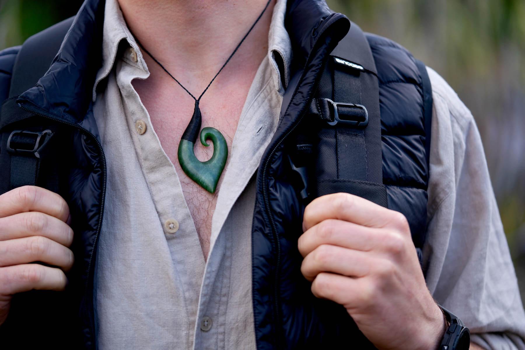 Model wears pounamu Hei Matau 