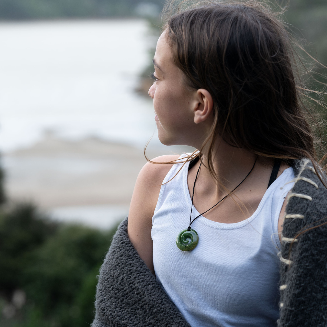 girl wearing a pounamu koru