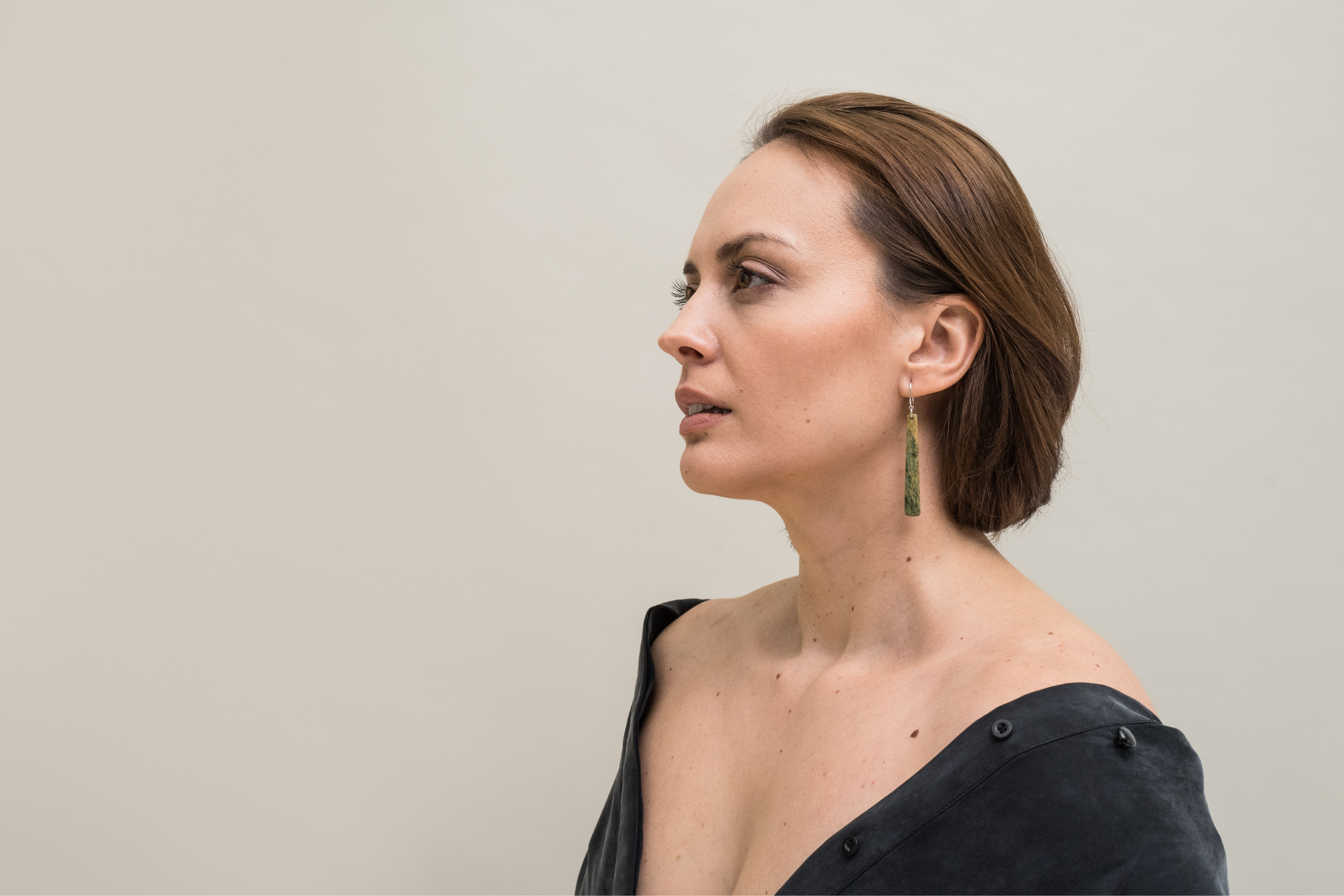 Model wearing pounamu earrings