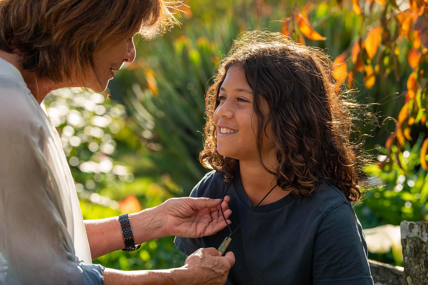 Lady presents grandson with pounamu drop