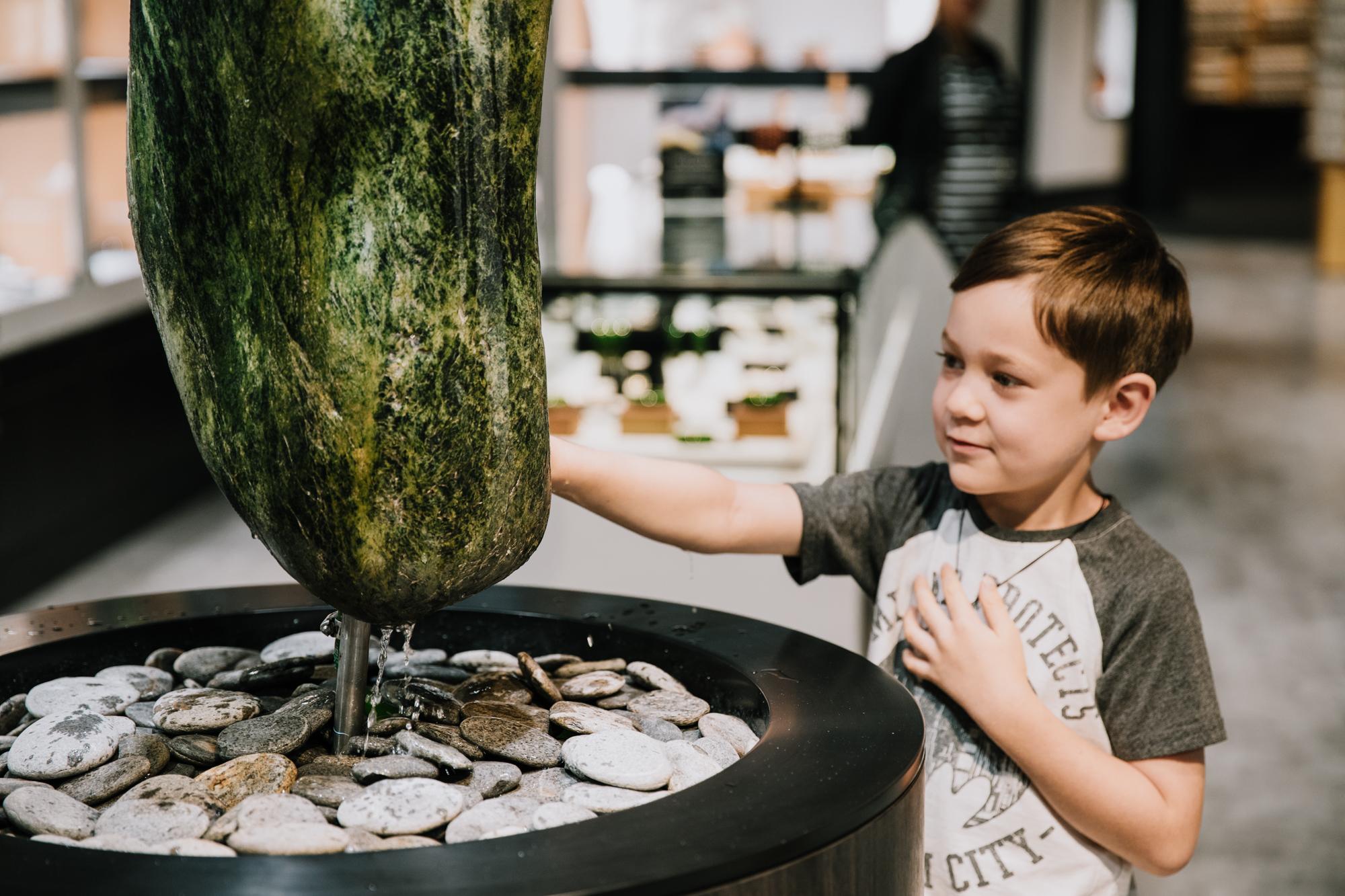 Boy touching jade stone