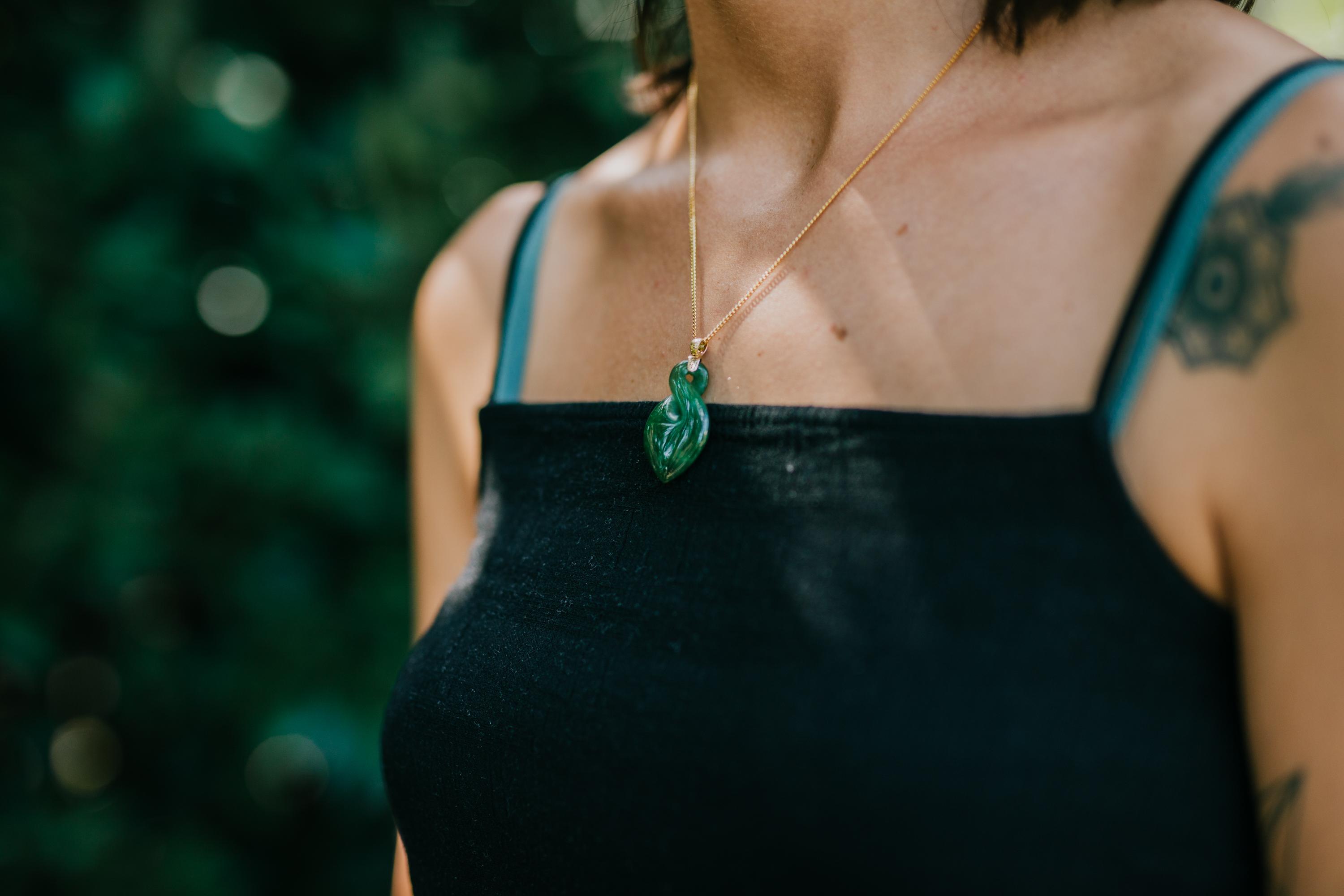 Model wearing a New Zealand Pounamu Twist design on gold bale