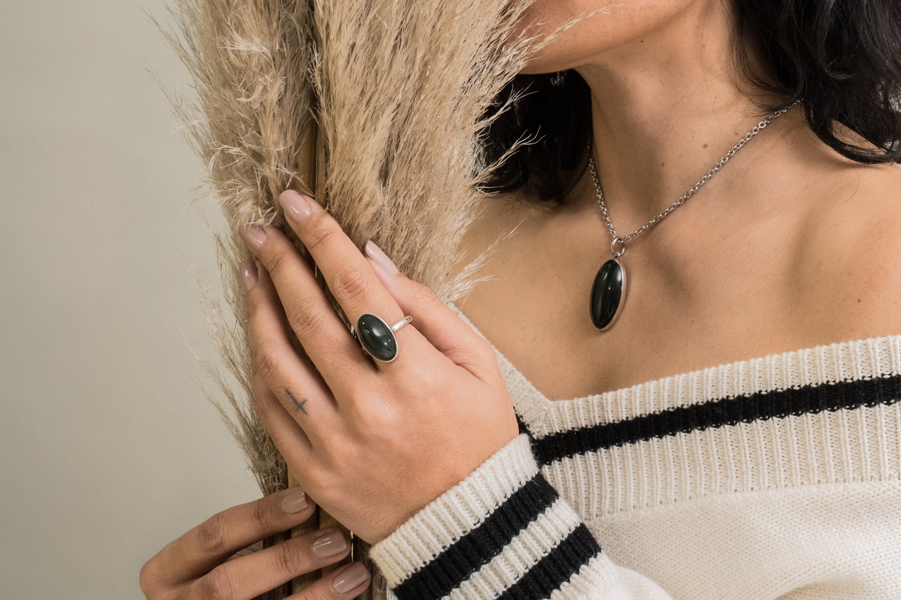 pounamu ring and necklace on model