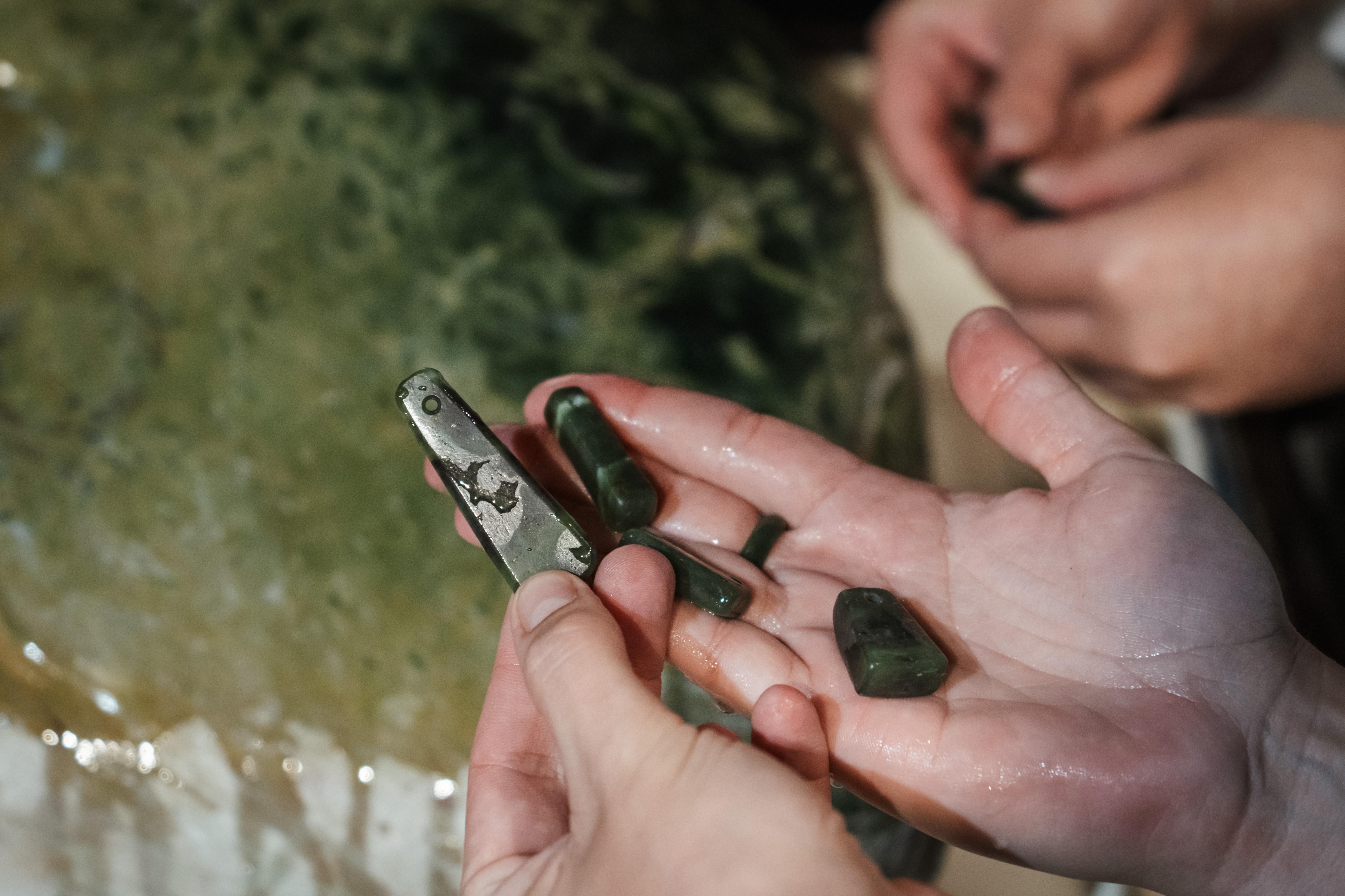 small pounamu stones in hand