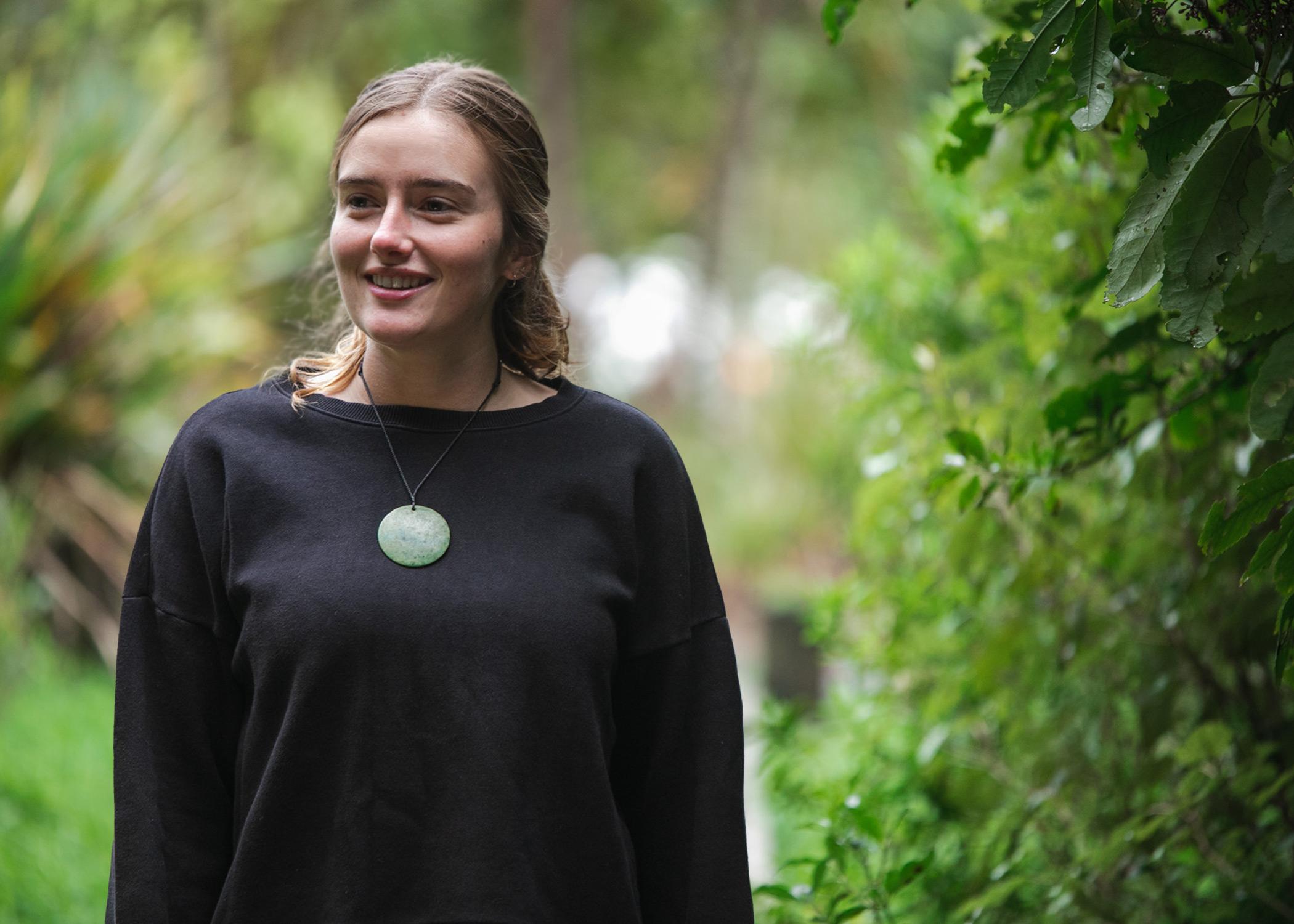 Lady wears New Zealand Pounamu Disc in beautiful setting