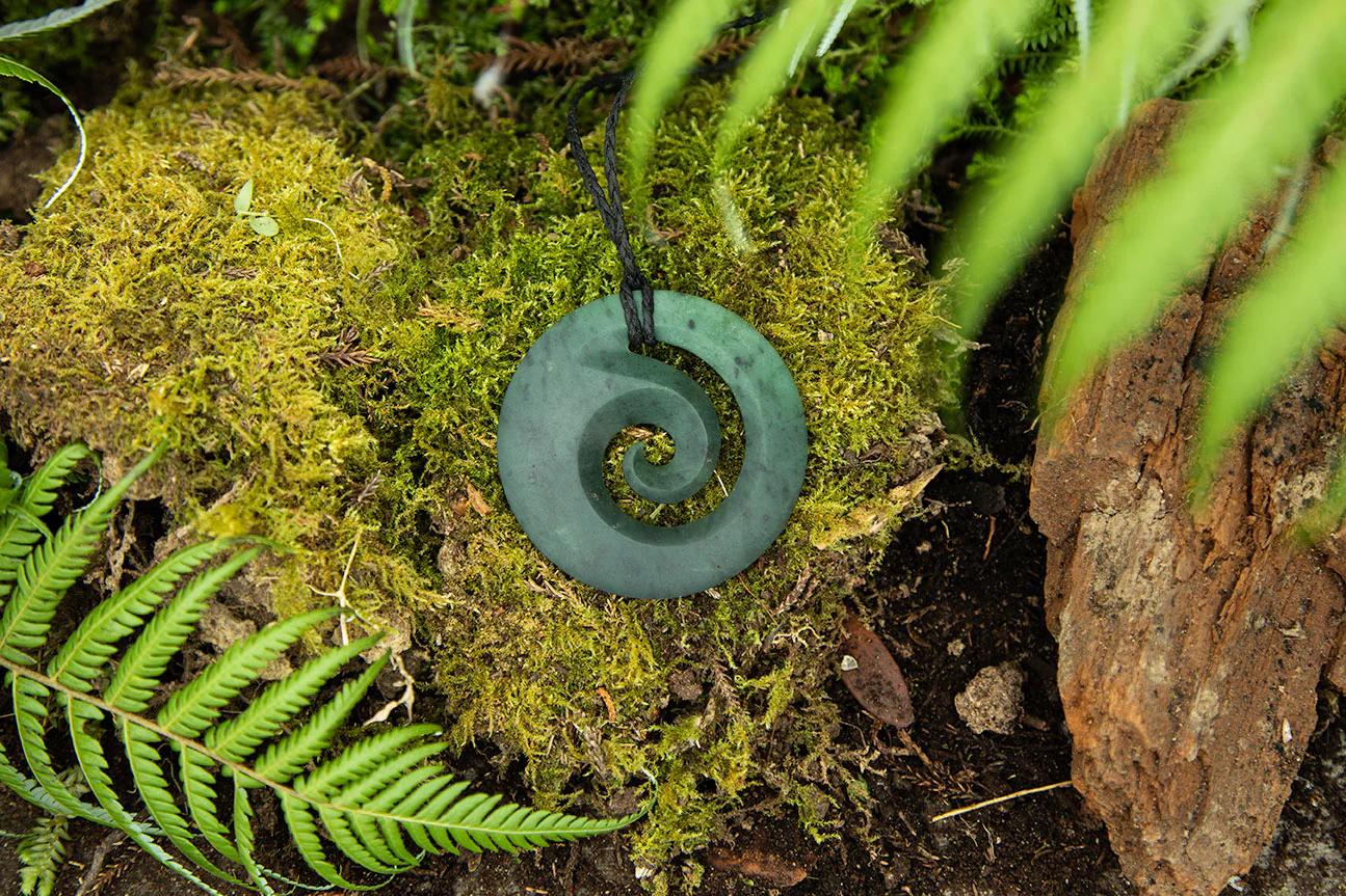 Koru necklace on mossy floor