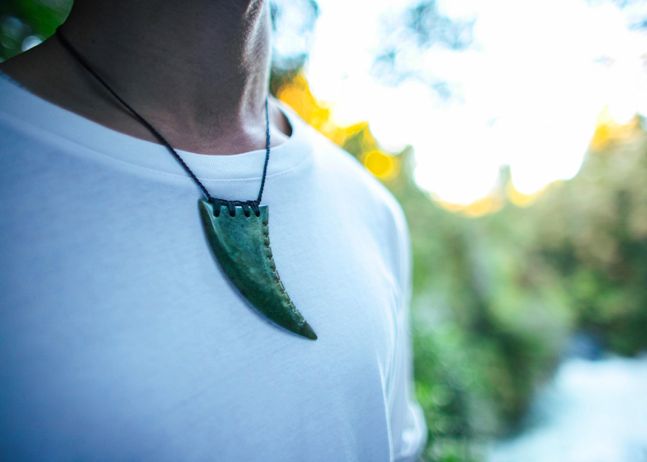 Man wearing pounamu tooth.