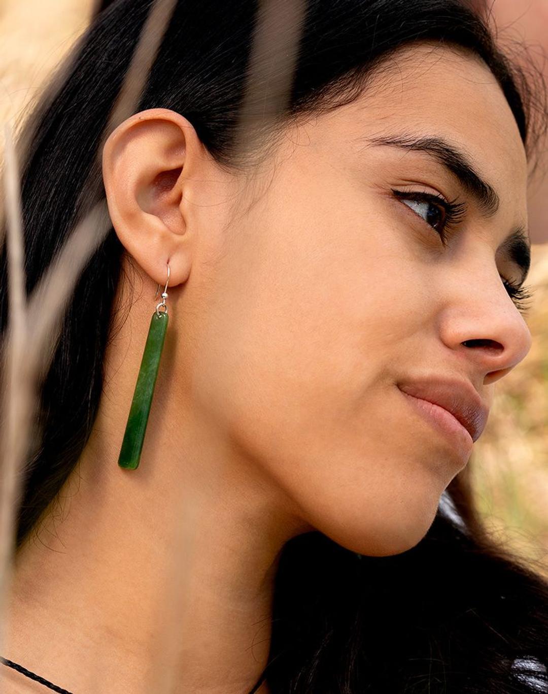 Girl wearing authentic pounamu drop earrings