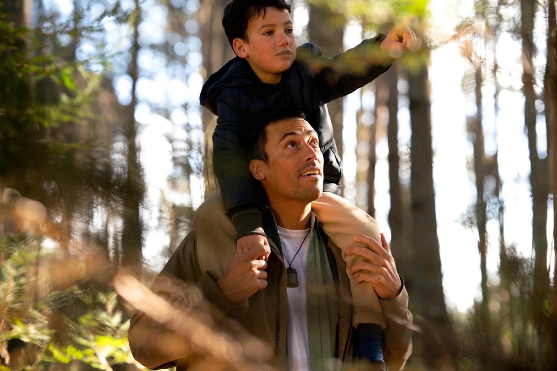 Father wearing toki carrying son