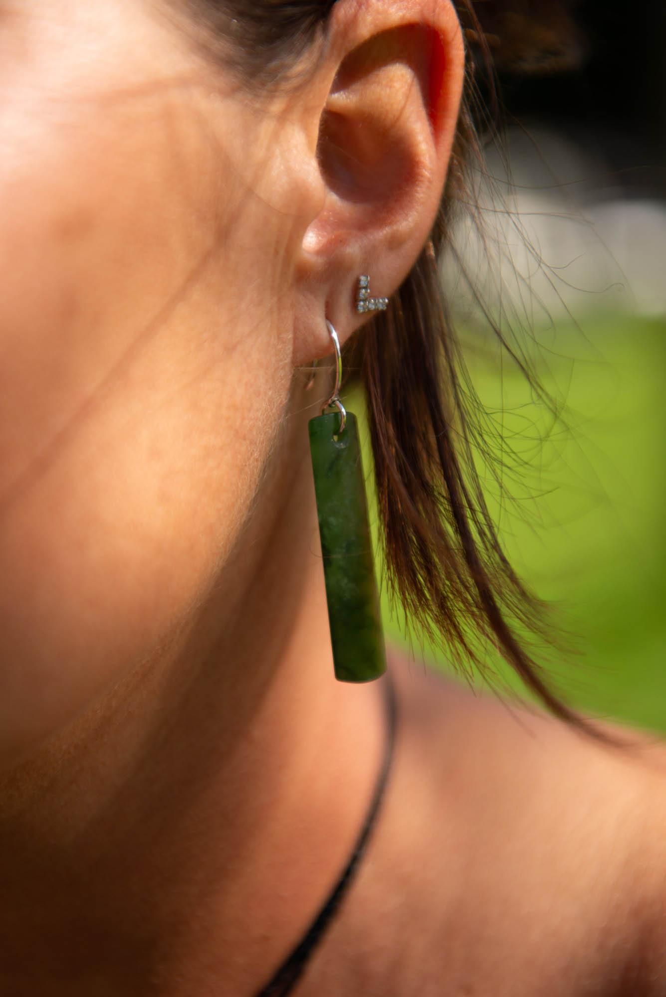 Model wearing pounamu earrings