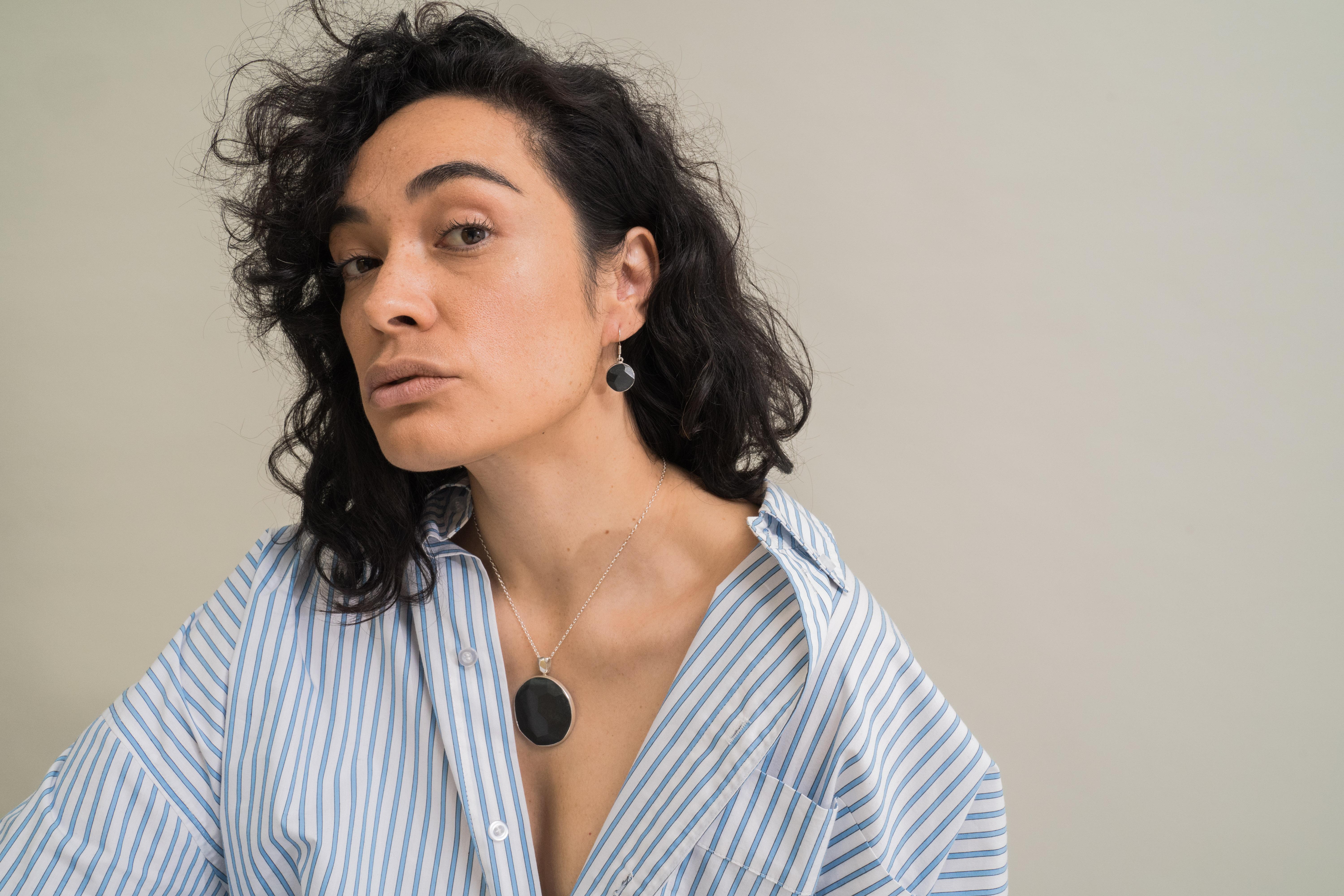 Model wearing black jade earrings and necklace