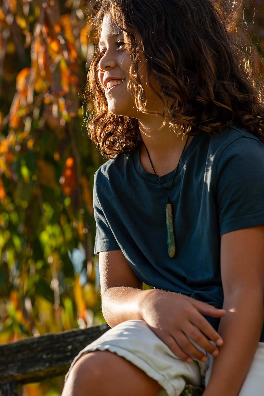 Boy wearing pounamu drop